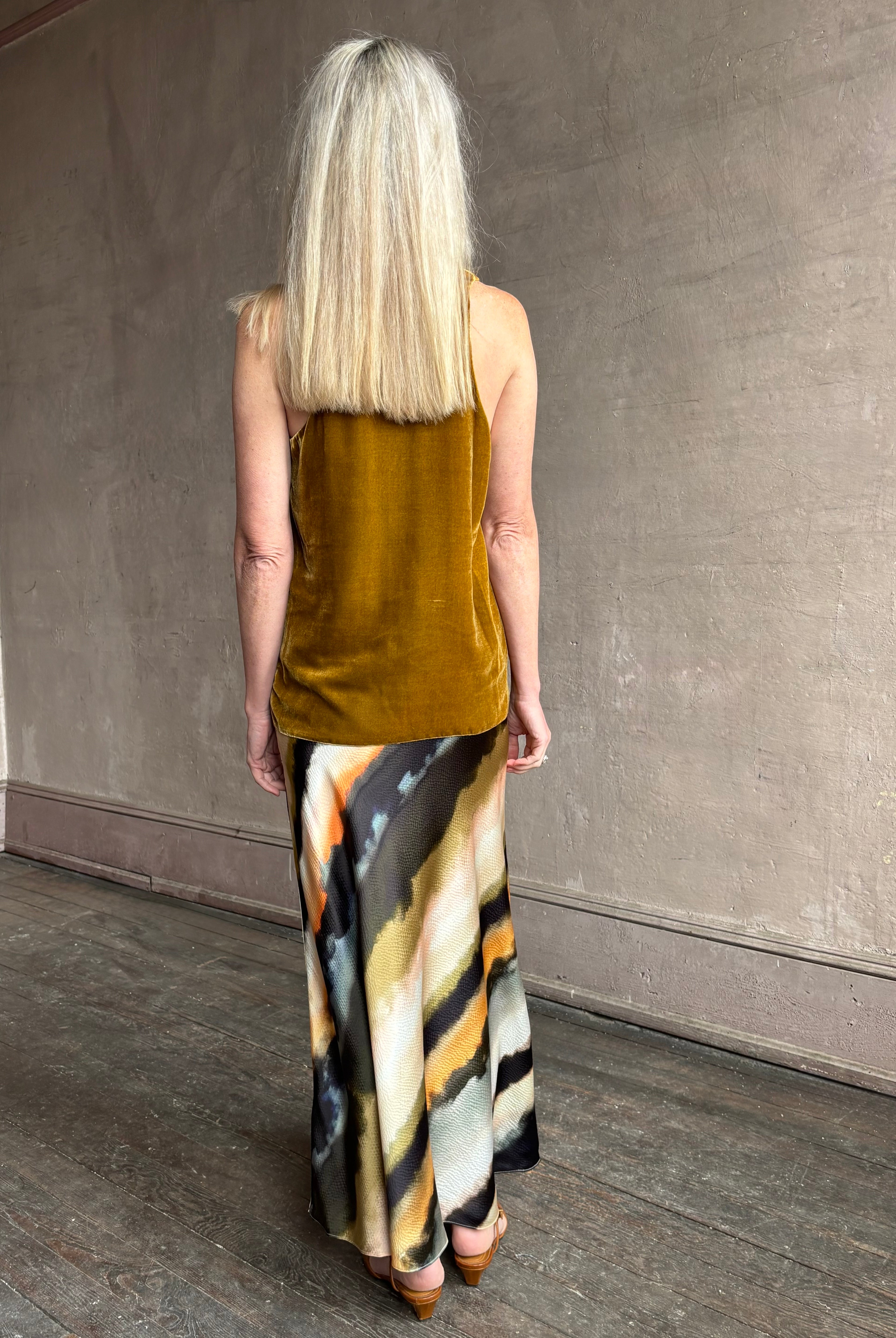 Image of mature woman wearing designer Cara Cara hammered silk maxi slip skirt with abstract multi-color print that can be dressed up or down
