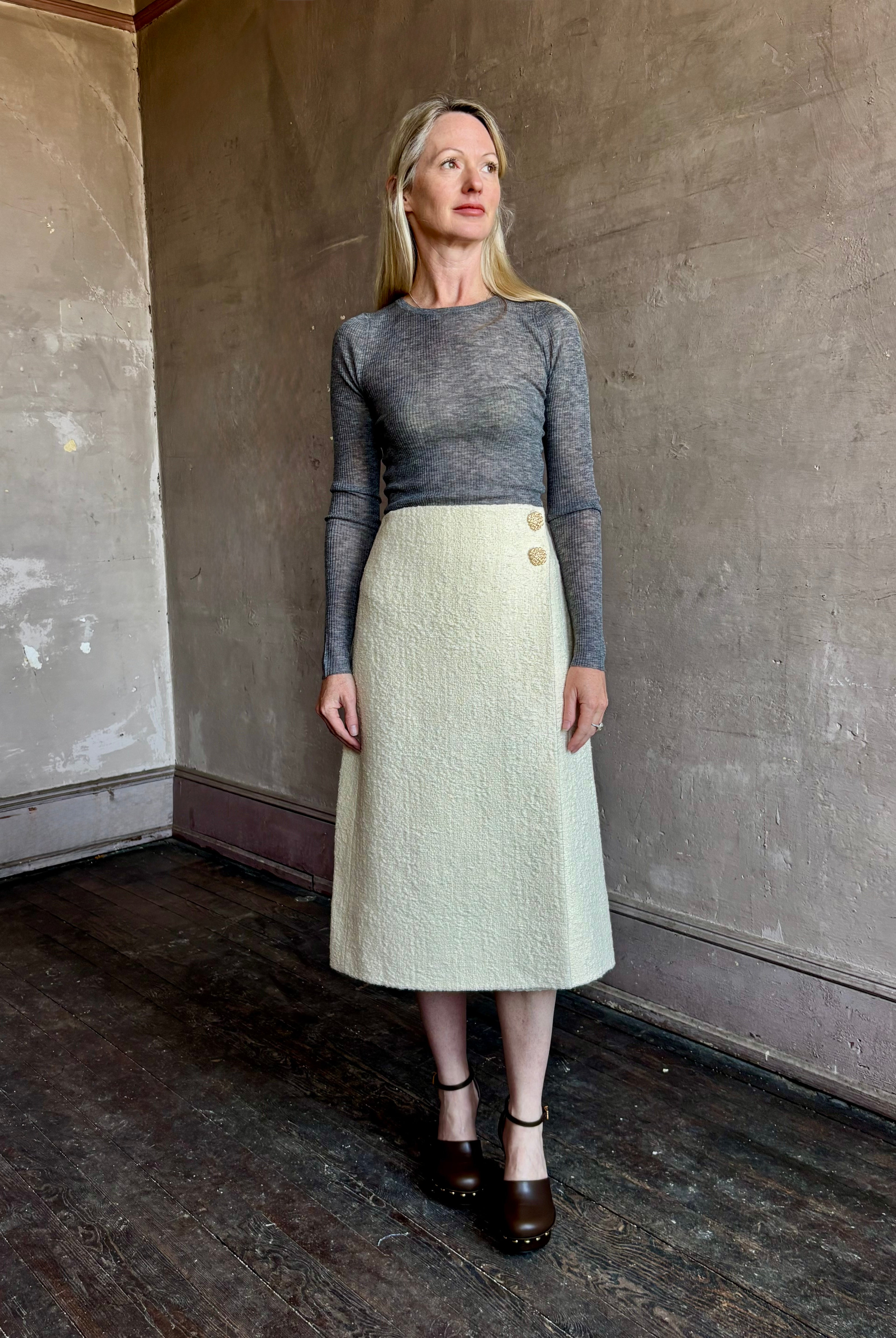 Image of woman wearing the premium tweed midi Luca skirt with faux wrap styling and textured fabrication by Cara Cara