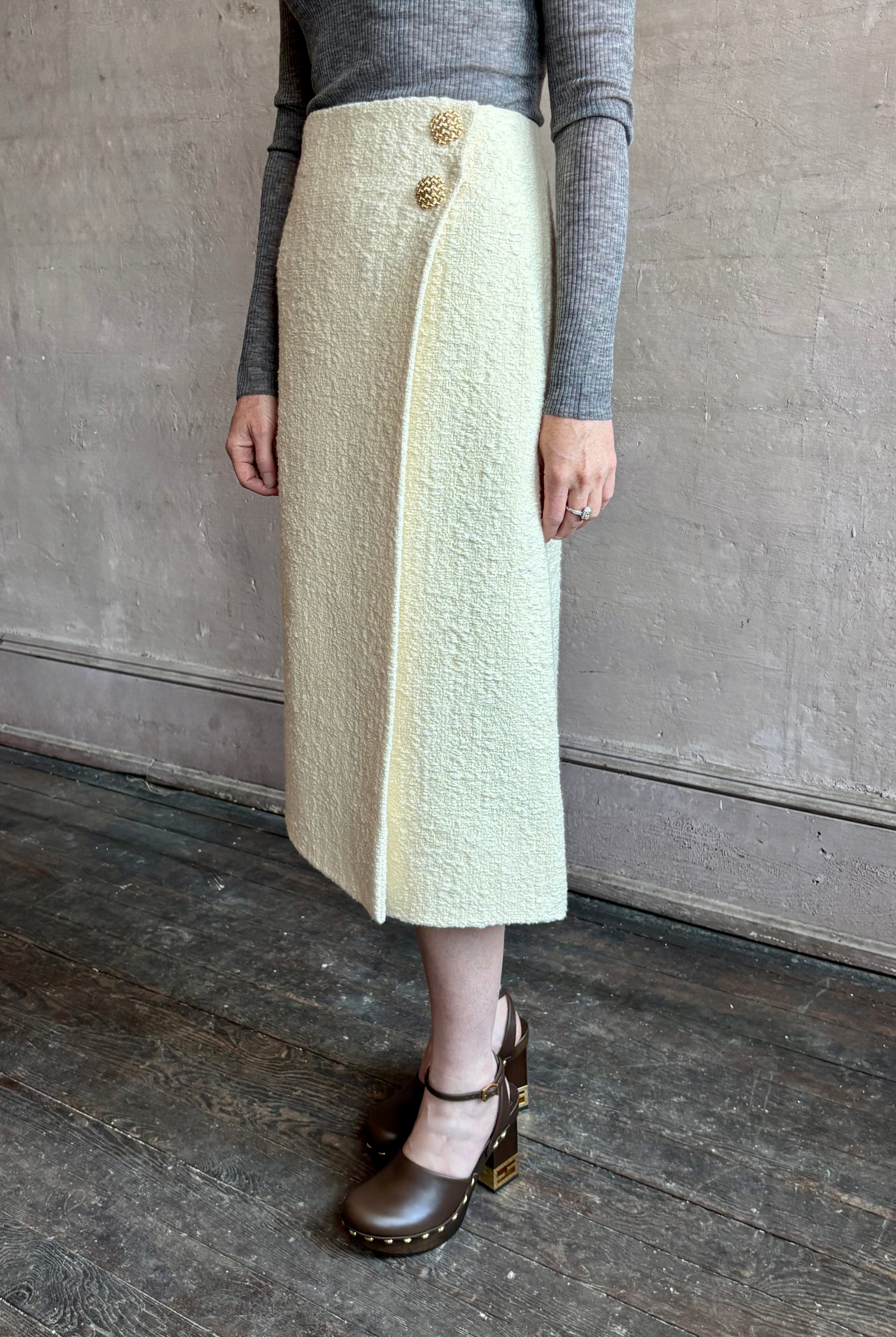 Image of woman wearing the premium cream tweed midi Luca skirt with faux wrap styling and textured fabrication by Cara Cara