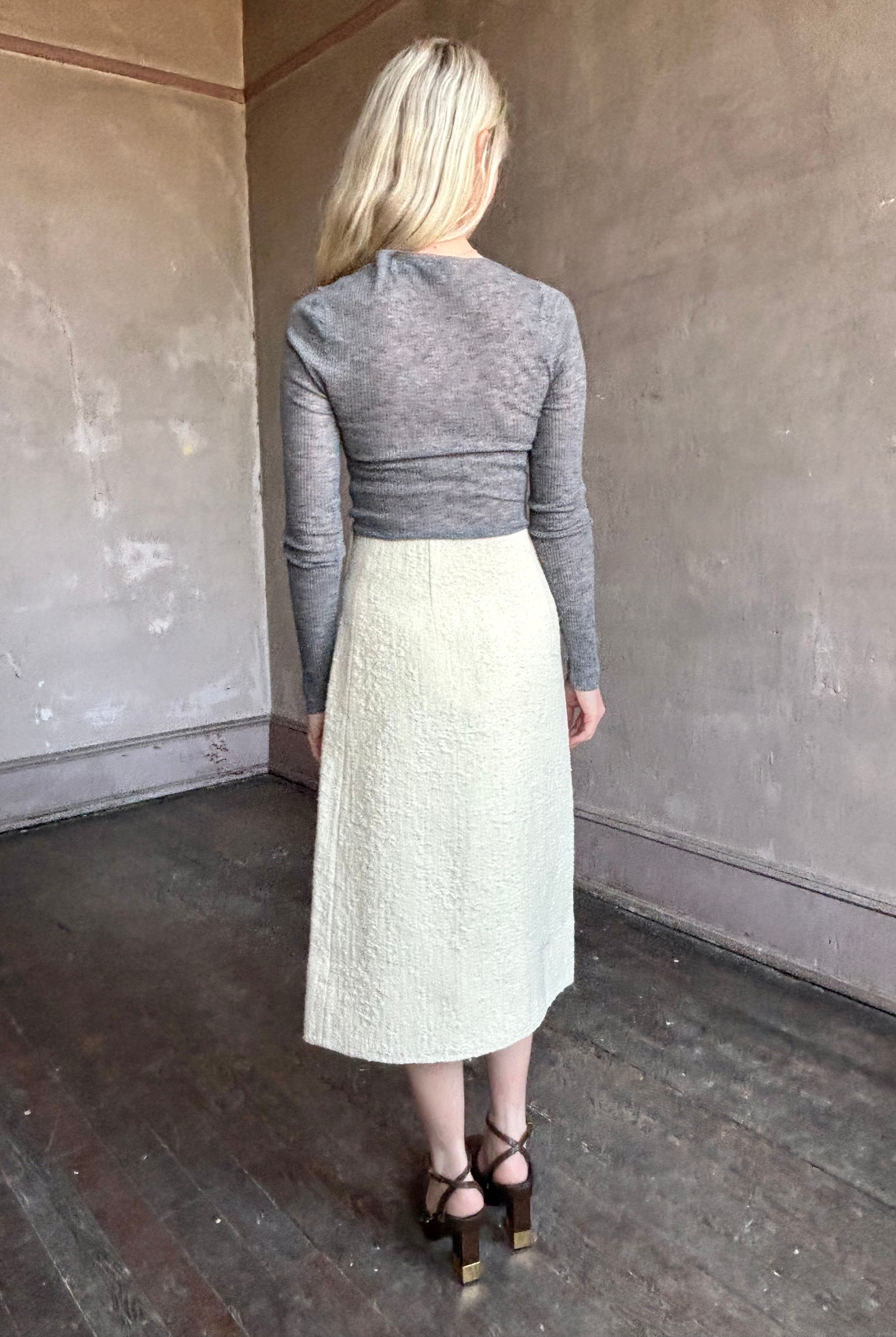 Image of woman wearing the Luca midi skirt with classic A line silhouette and textured tweed fabrication by Cara Cara