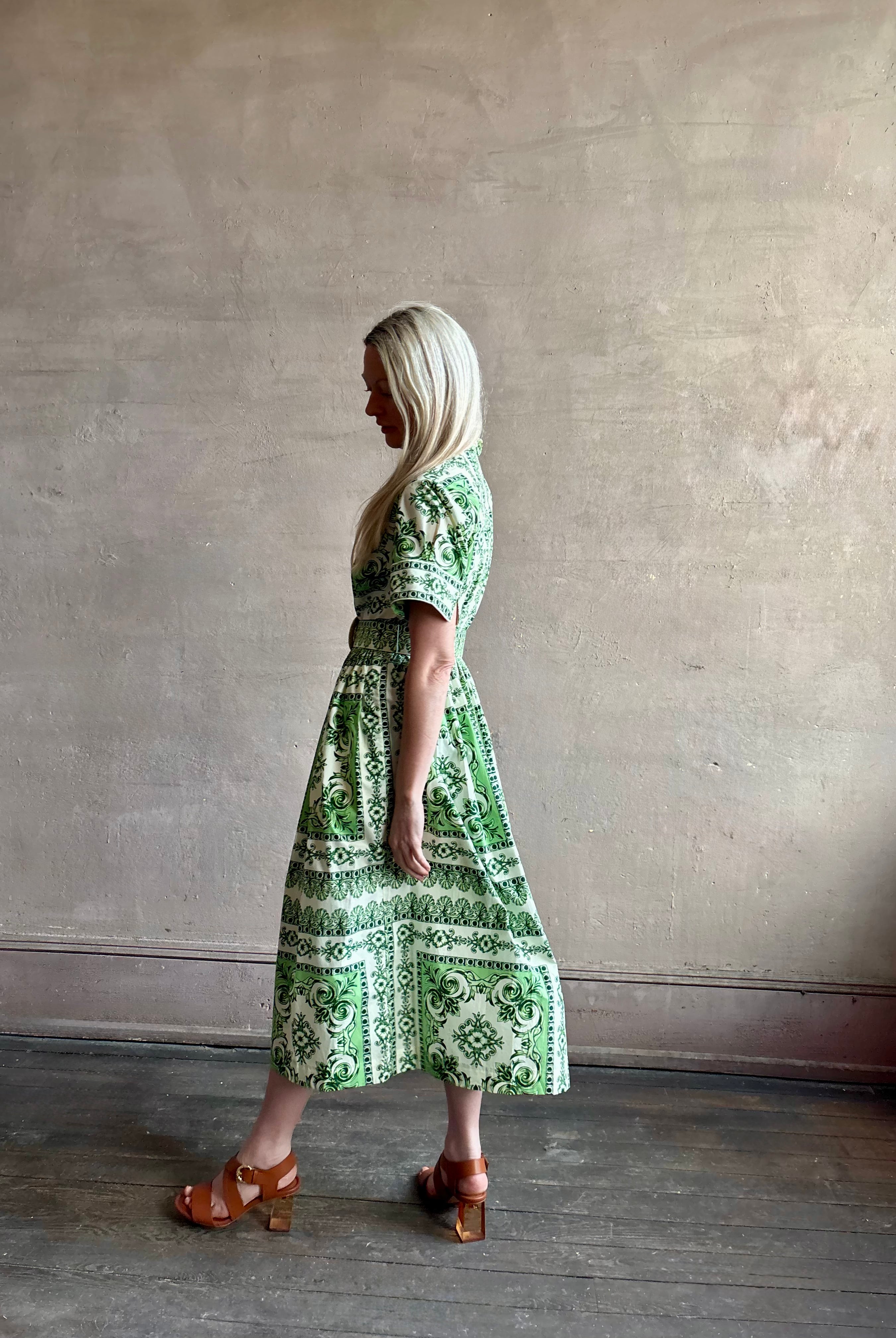 Woman wearing Cara Cara designer Malena cotton poplin shirt dress in a green Hudson Scarf Mint print with short sleeves ad belt