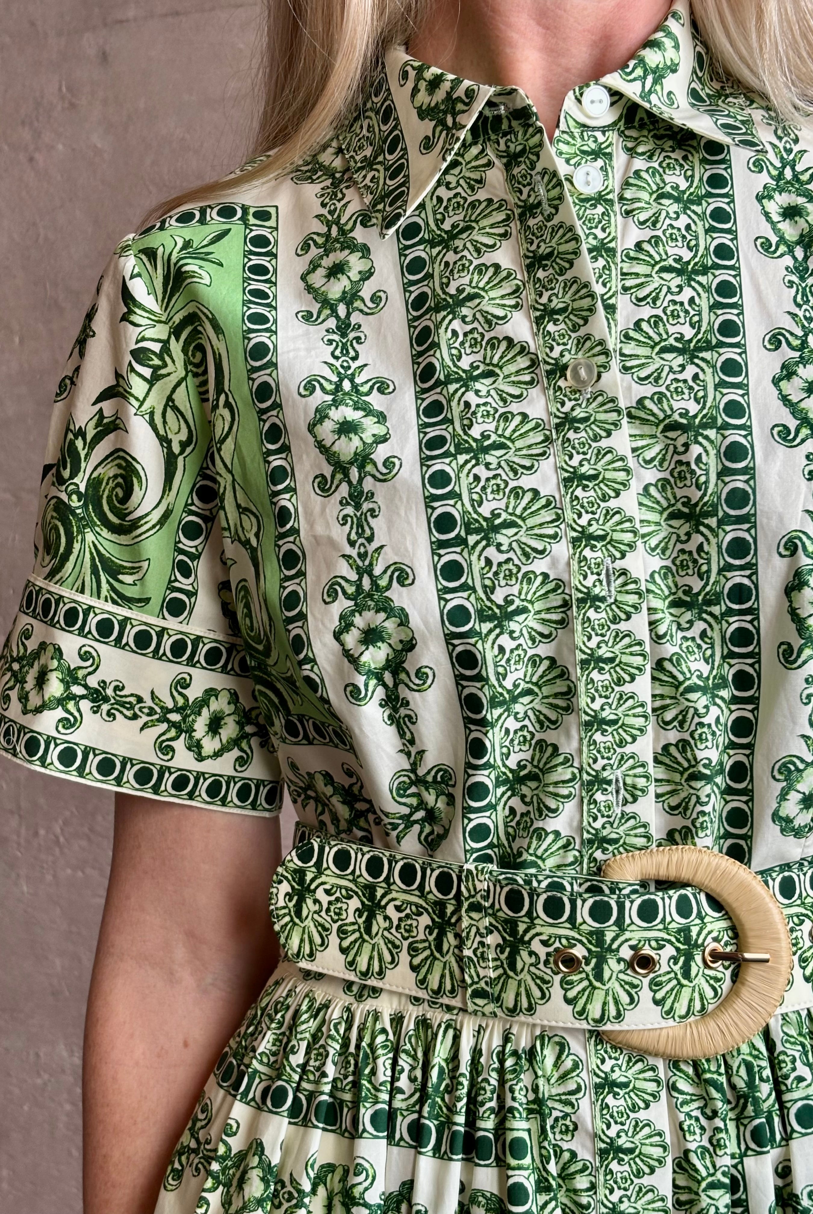 Woman wearing Cara Cara designer Malena cotton poplin shirt dress in a green Hudson Scarf Mint print with short sleeves ad belt