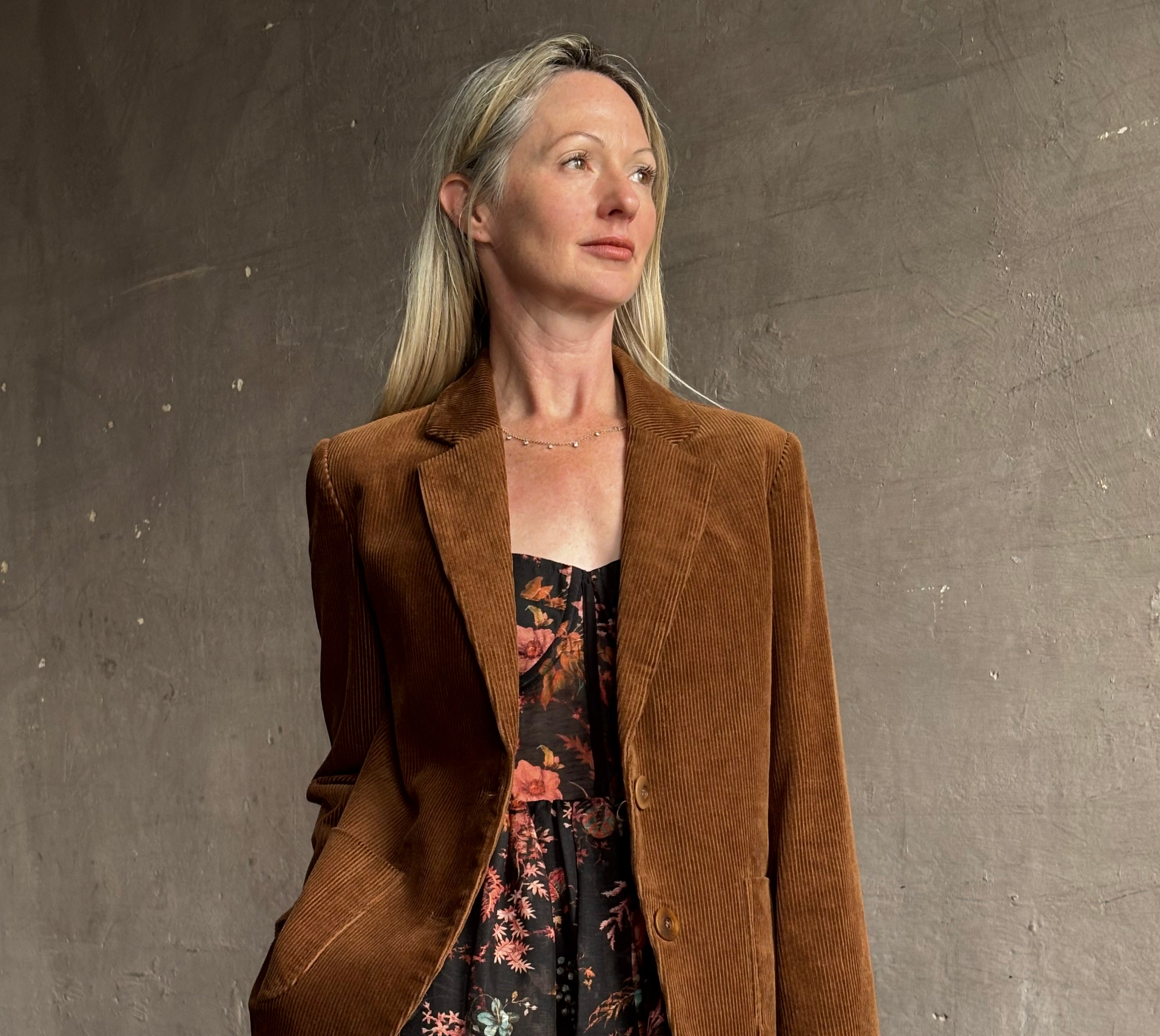 Image of woman wearing premium linen-silk Pheobe midi dress by Cara Cara with expertly crafted unlined corset bodice in an elegant black floral print