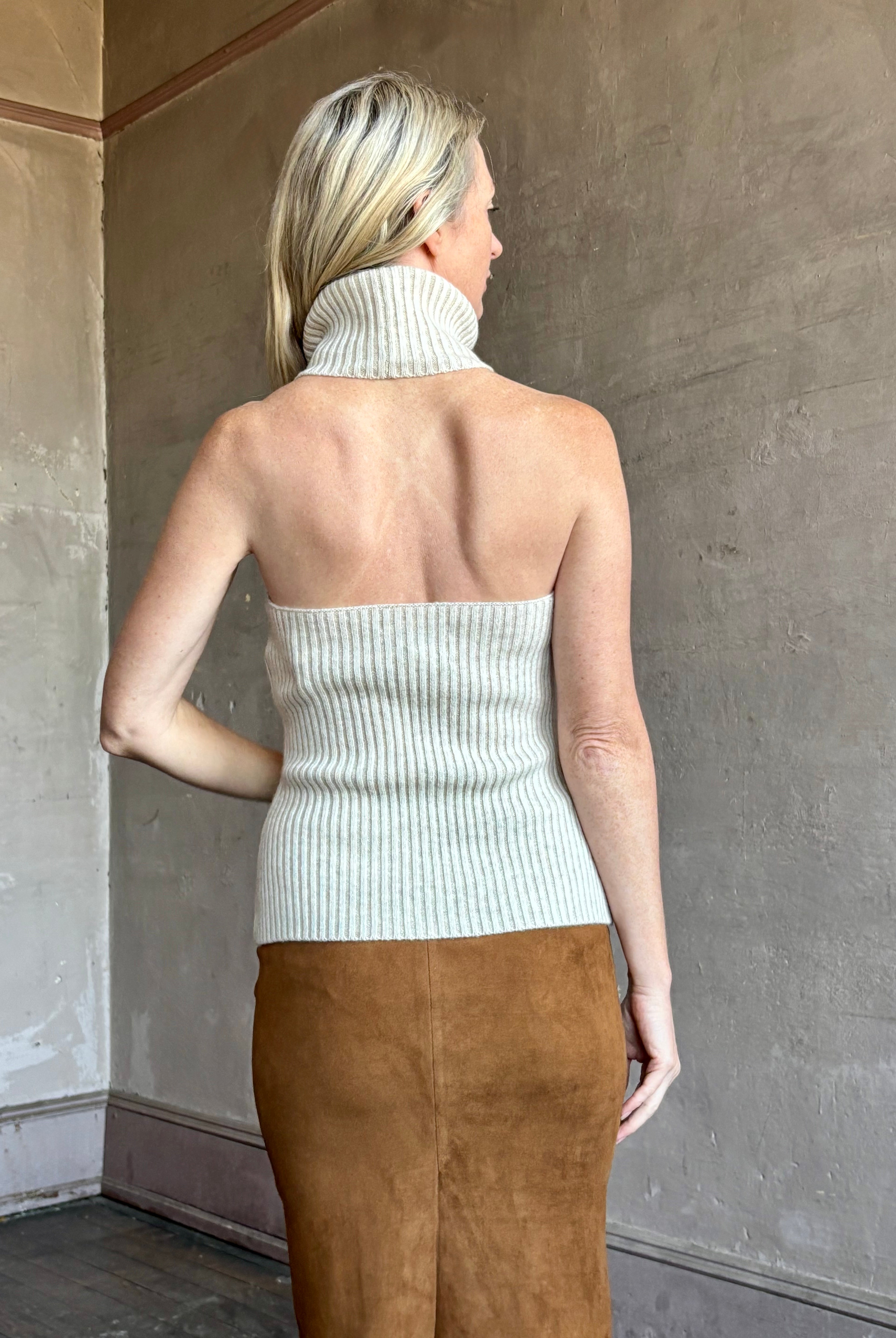 Image of mature woman wearing the Cara Cara Samson Top in neutral knit with turtleneck and halter top design in a luxury wool and cashmere blend