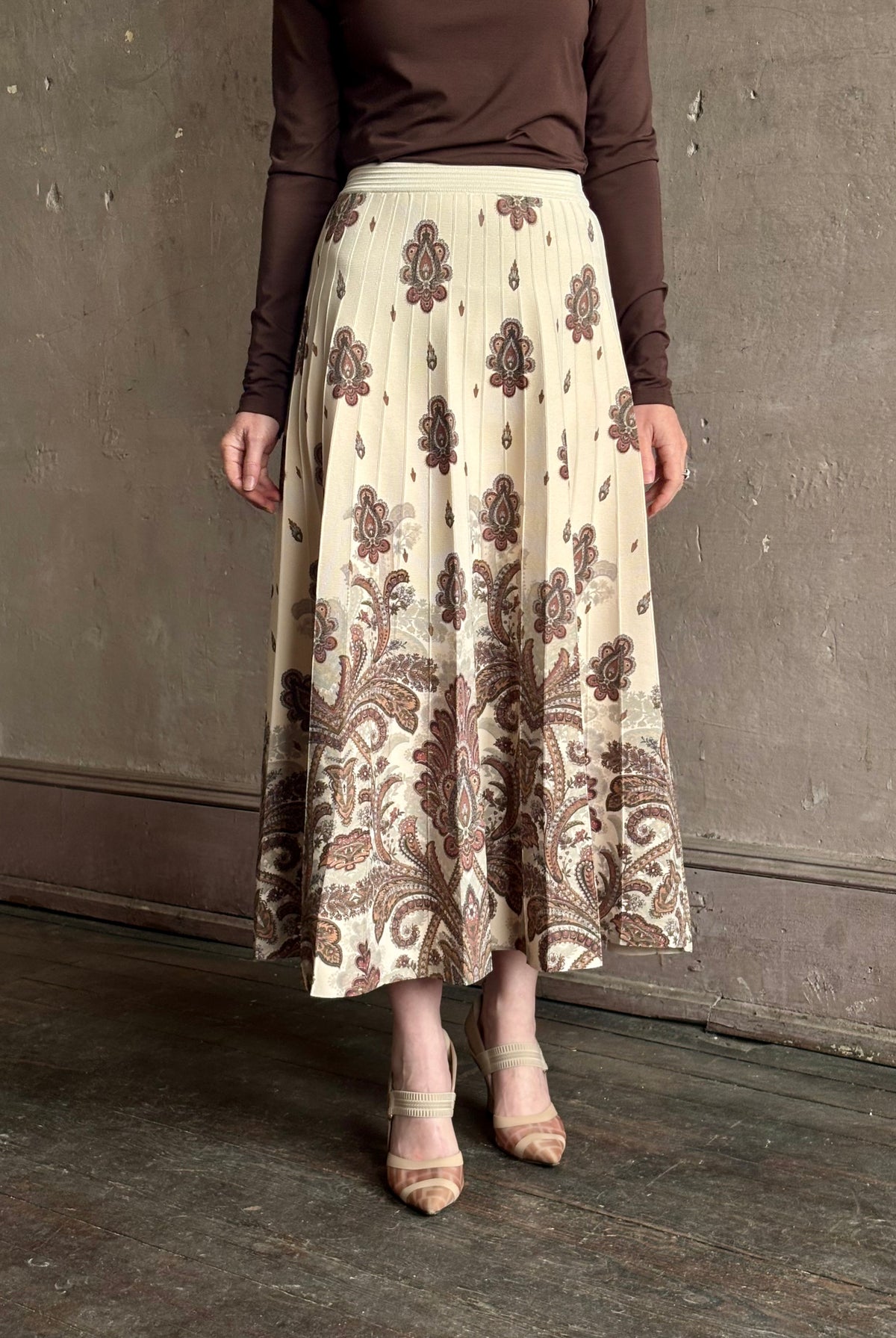 Mature woman wearing designer Cara Cara Tavira A-line Skirt in Castle Paisley Ivory heavy knit tonal paisley print understated everyday sophistication