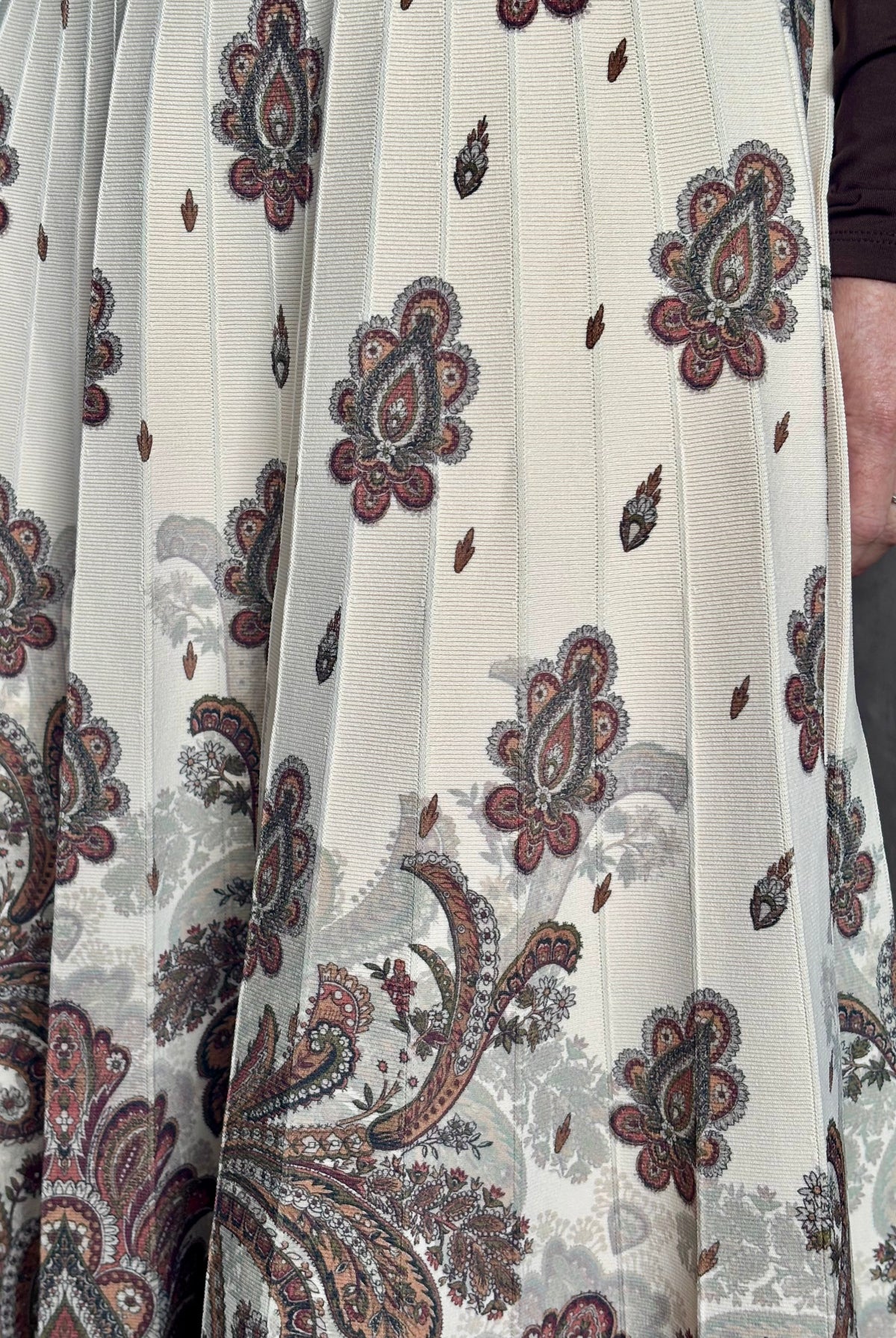 Mature woman wearing designer Cara Cara Tavira A-line Skirt in Castle Paisley Ivory heavy knit tonal paisley print understated everyday sophistication