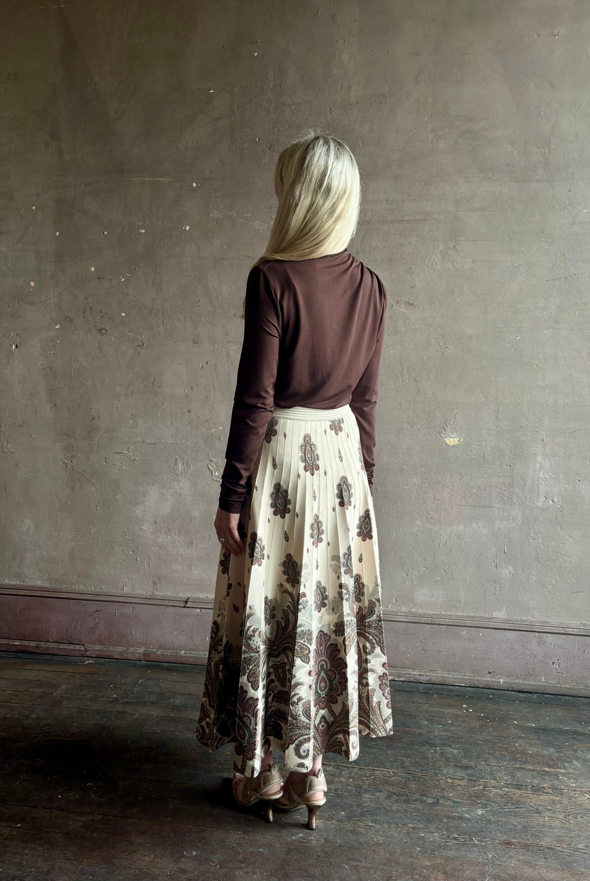 Mature woman wearing designer Cara Cara Tavira A-line Skirt in Castle Paisley Ivory heavy knit tonal paisley print understated everyday sophistication