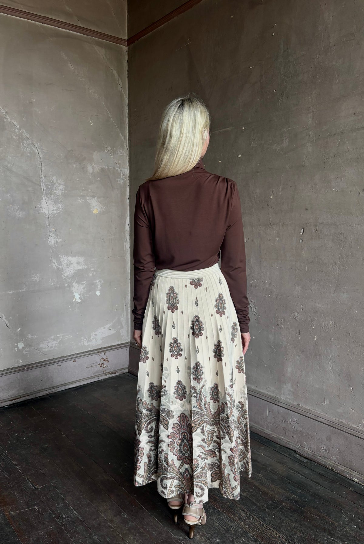 Mature woman wearing designer Cara Cara Tavira A-line Skirt in Castle Paisley Ivory heavy knit tonal paisley print understated everyday sophistication