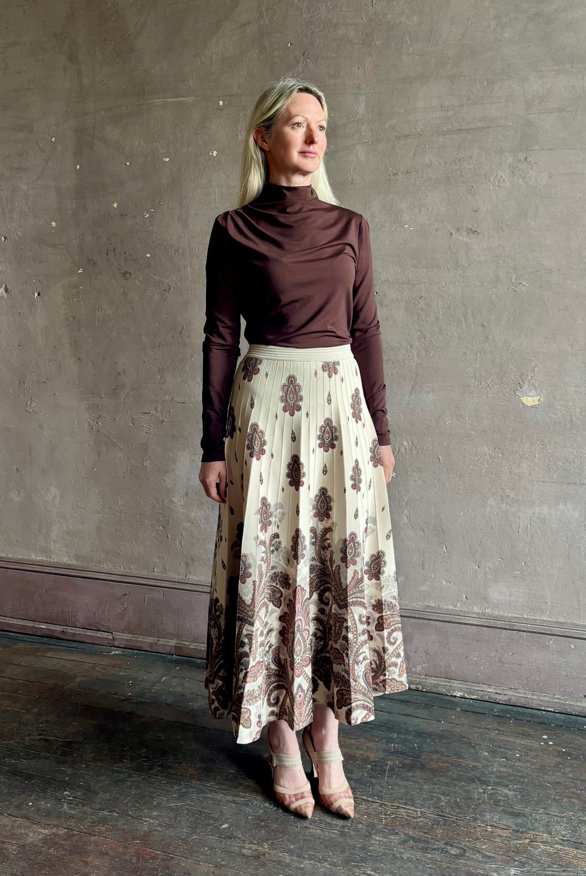 Mature woman wearing designer Cara Cara Tavira A-line Skirt in Castle Paisley Ivory heavy knit tonal paisley print understated everyday sophistication