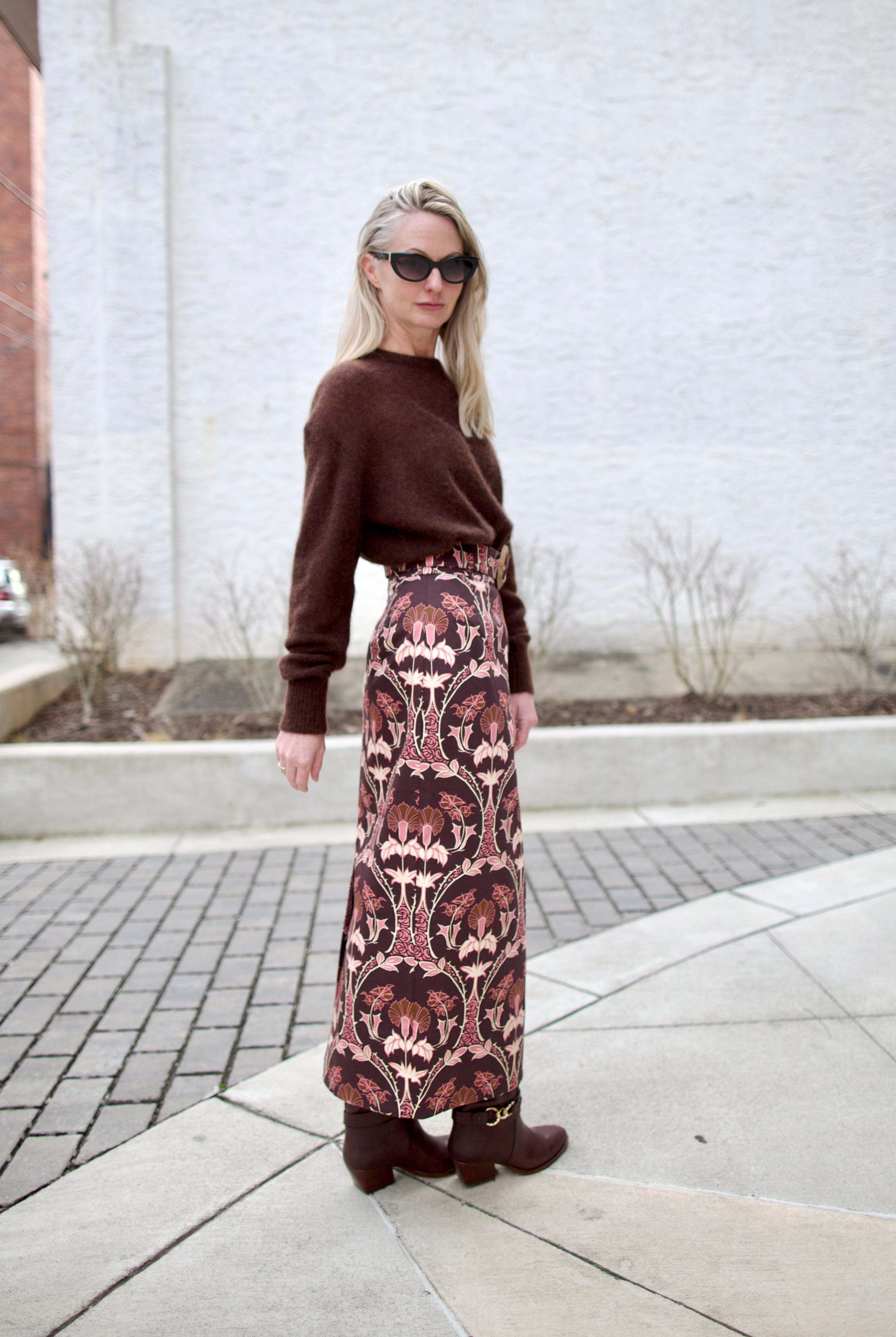 image of a woman wearing the cara cara arcada skirt, ulla johnson willow boots and apiece apart tissue weight sweater