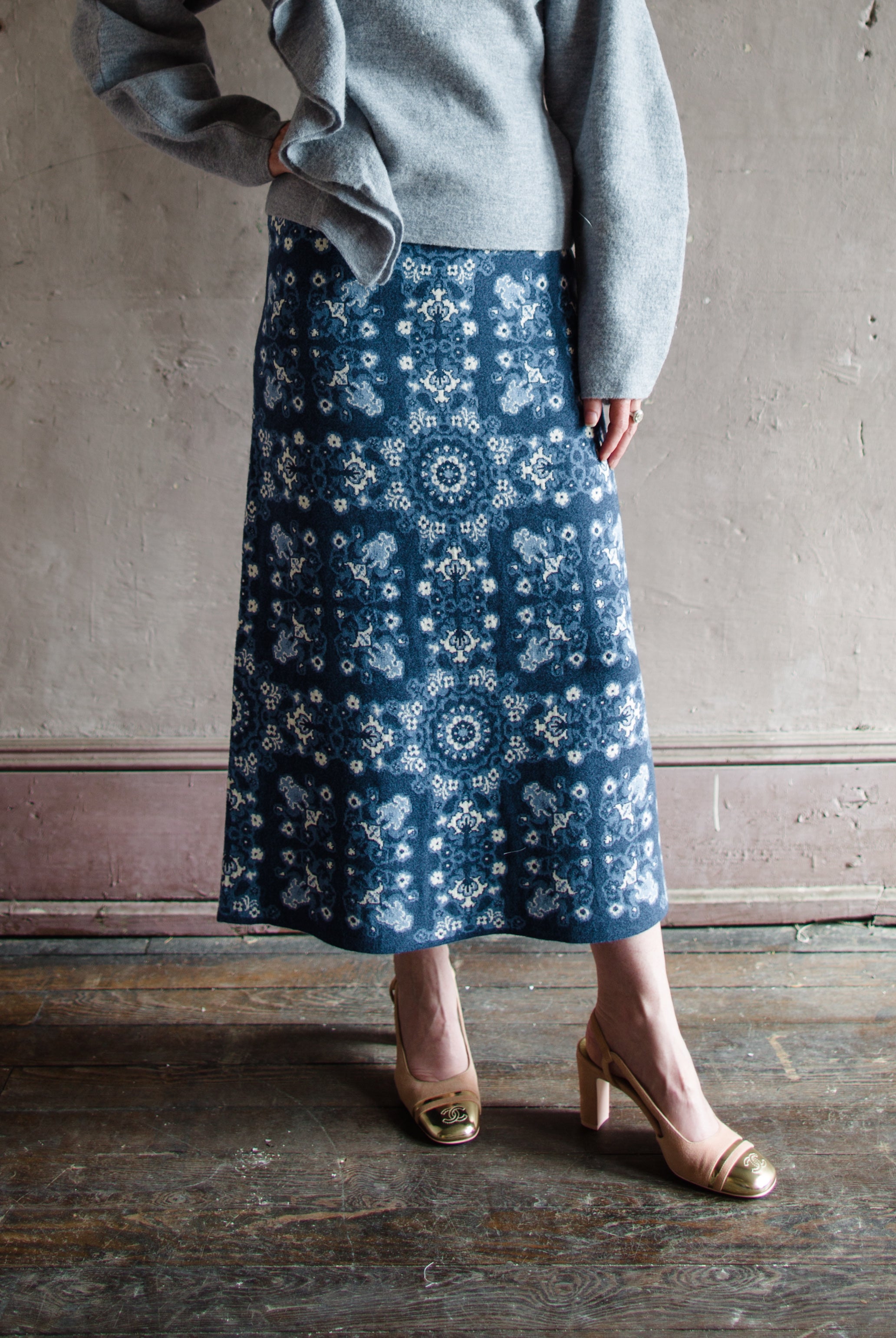 Image featuring a woman wearing the cashmere and cotton skirt by Cara Cara with a high rise and a-line fit in a beautiful knit texture in Blue Rita colorway.