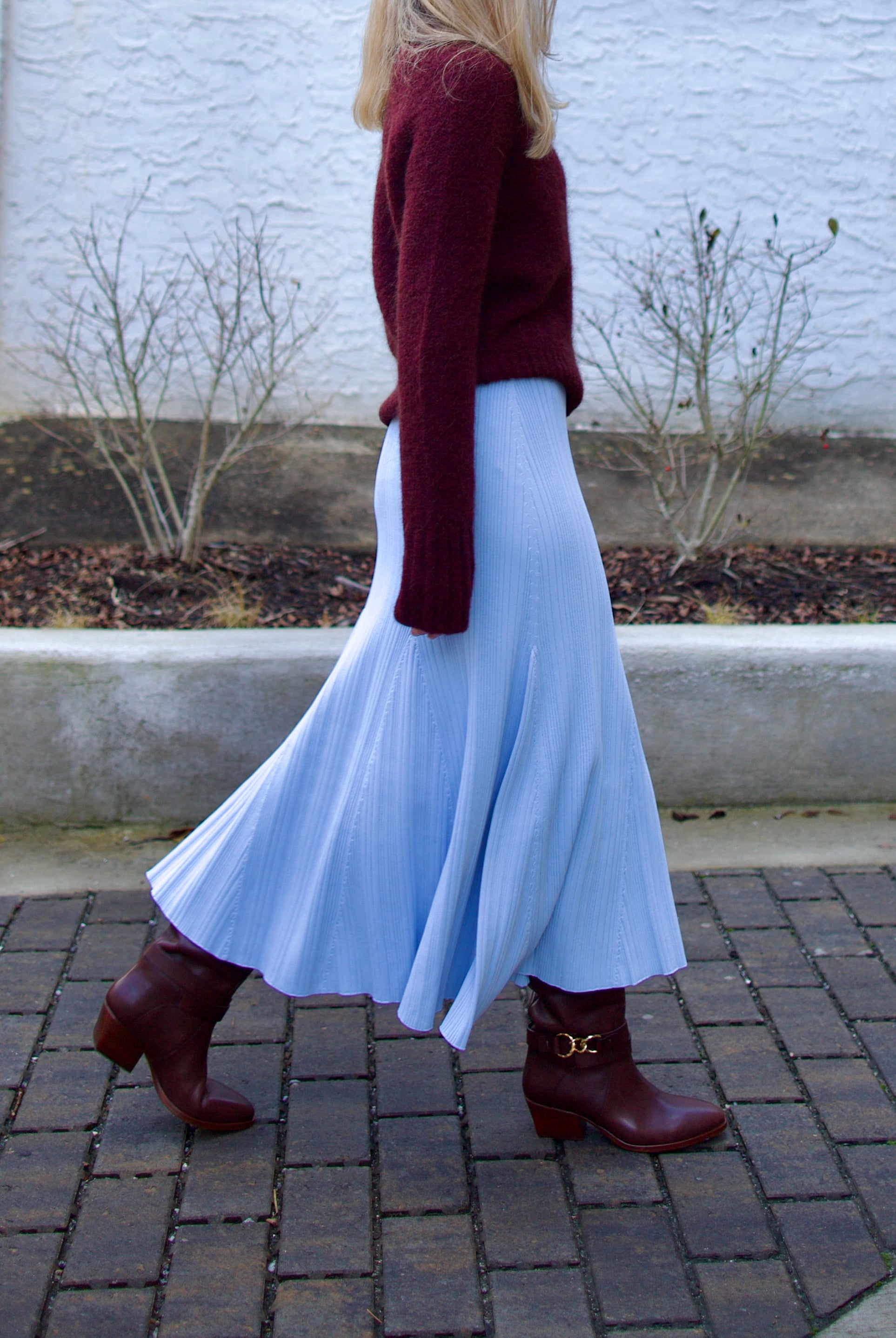 Image of woman wearing Cara Cara Dara Skirt in Sky Blue viscose-nylon-spandex construction with elegant ribbed texture, high-rise waist, and slightly flared hem