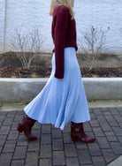 Image of woman wearing Cara Cara Dara Skirt in Sky Blue viscose-nylon-spandex construction with elegant ribbed texture, high-rise waist, and slightly flared hem
