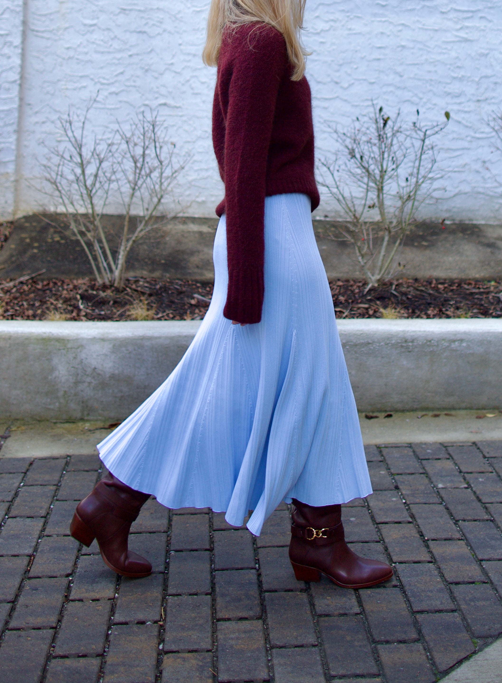 Image of woman wearing Cara Cara Dara Skirt in Sky Blue viscose-nylon-spandex construction with elegant ribbed texture, high-rise waist, and slightly flared hem