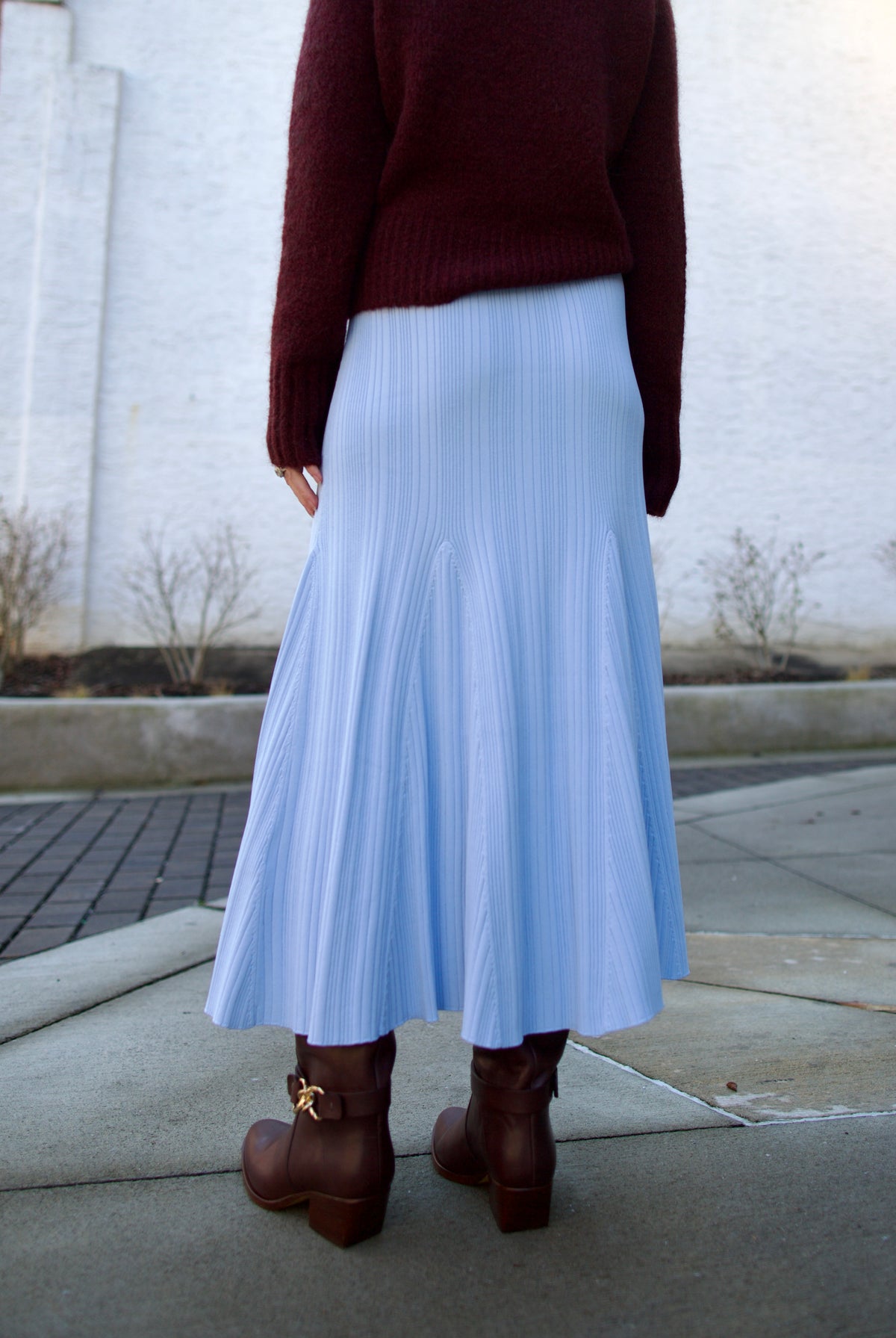 back image of mature woman wearing Cara Cara dara fit and flare knit skirt layered with a fall sweater perfect for layered look