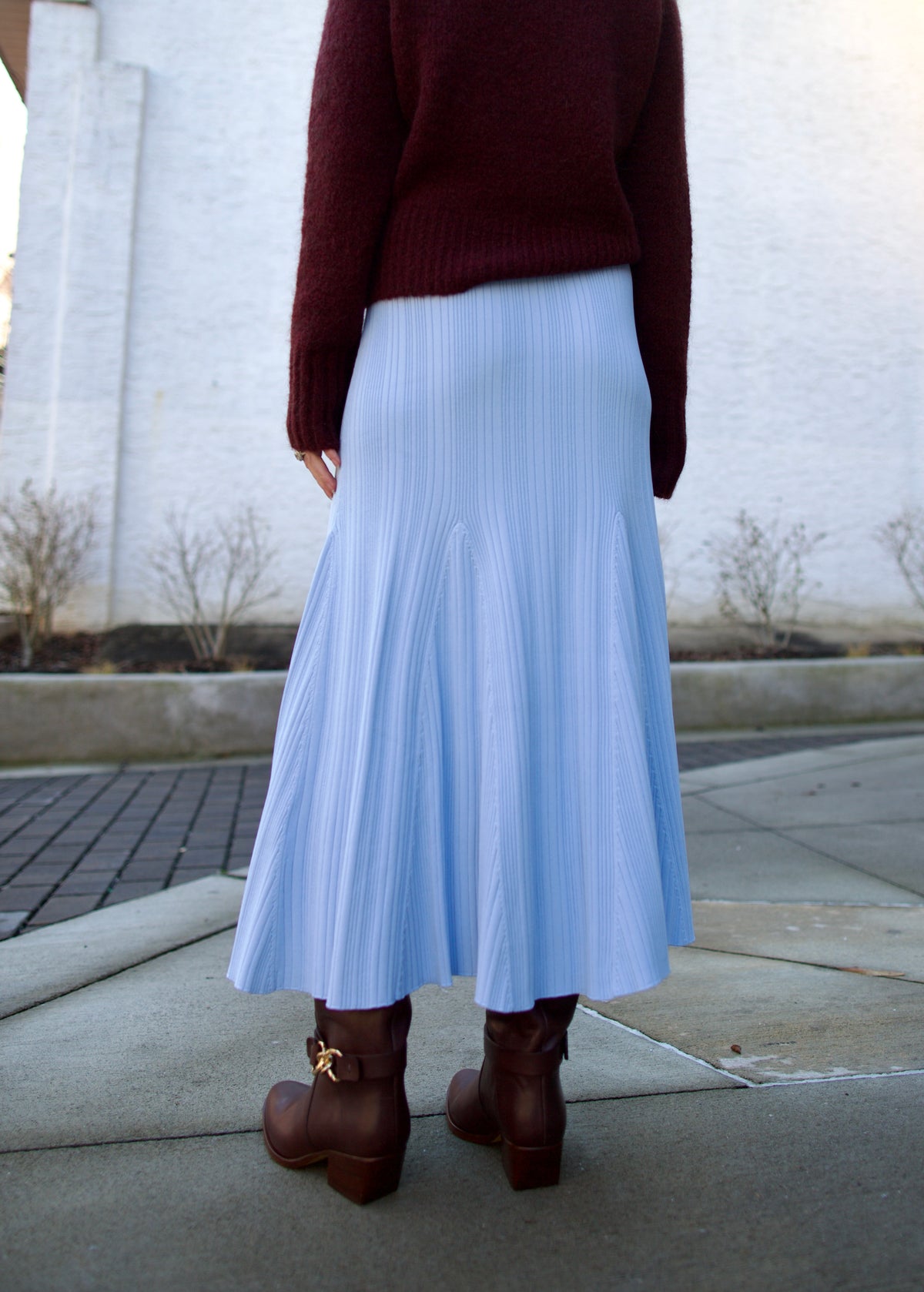 back image of mature woman wearing Cara Cara dara fit and flare knit skirt layered with a fall sweater perfect for layered look