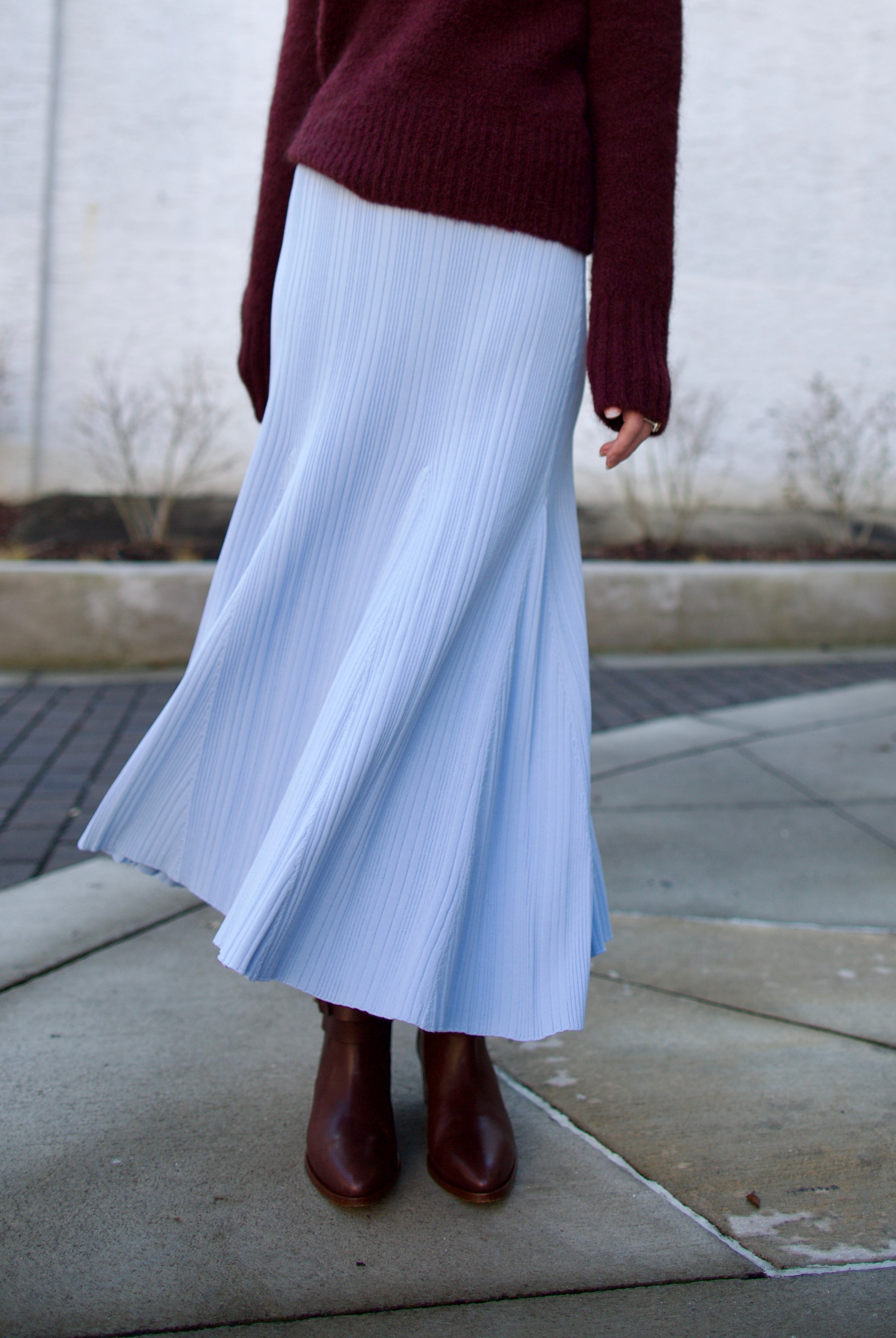 Image of woman wearing Cara Cara Dara Skirt in Sky Blue viscose-nylon-spandex construction with elegant ribbed texture, high-rise waist, and slightly flared hem