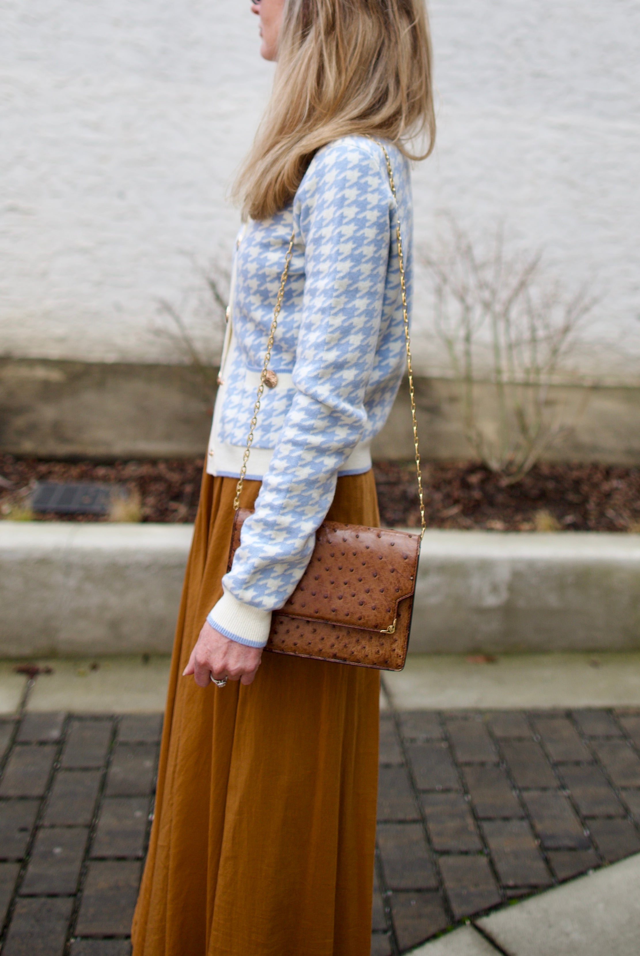 close up image of a woman wearing the Cara Cara priscilla cardigan and forte forte skirt.