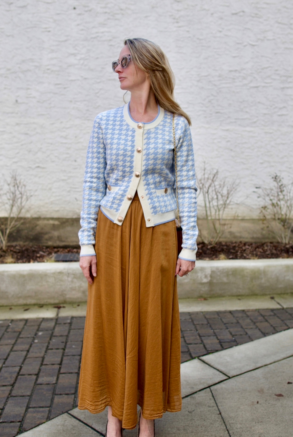 image of a woman wearing the Cara cara priscilla cardigan and Forte Forte Voile Skirt