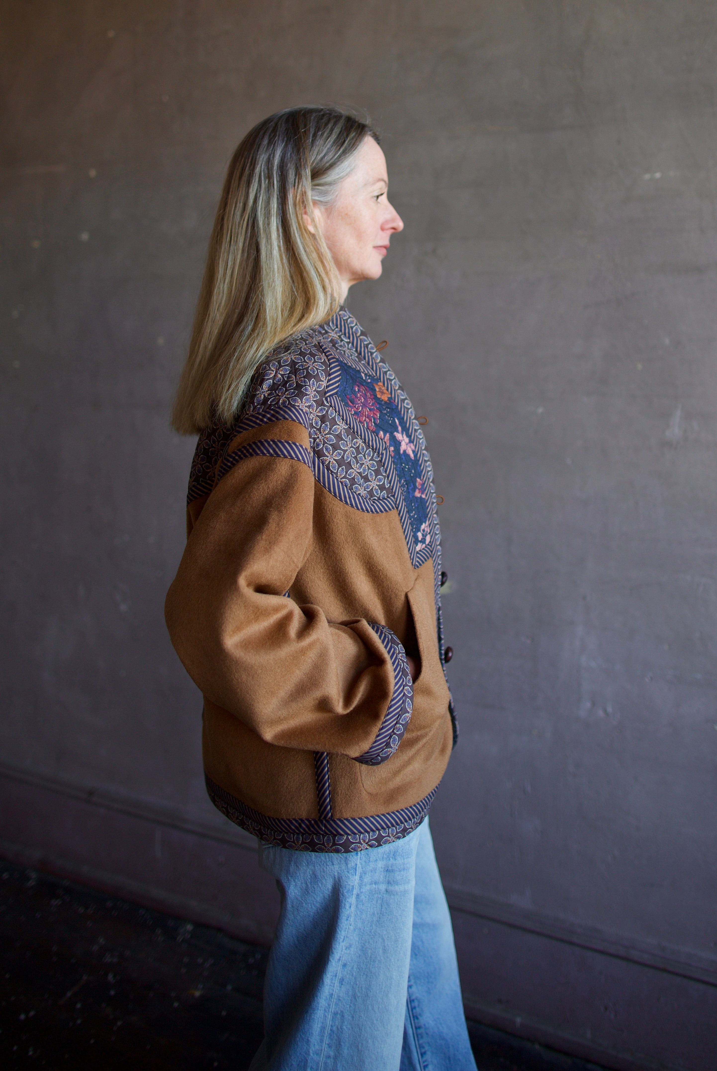 Side view image of a woman wearing the Cara Cara Ford Jacket and the slvrlake grace jeans