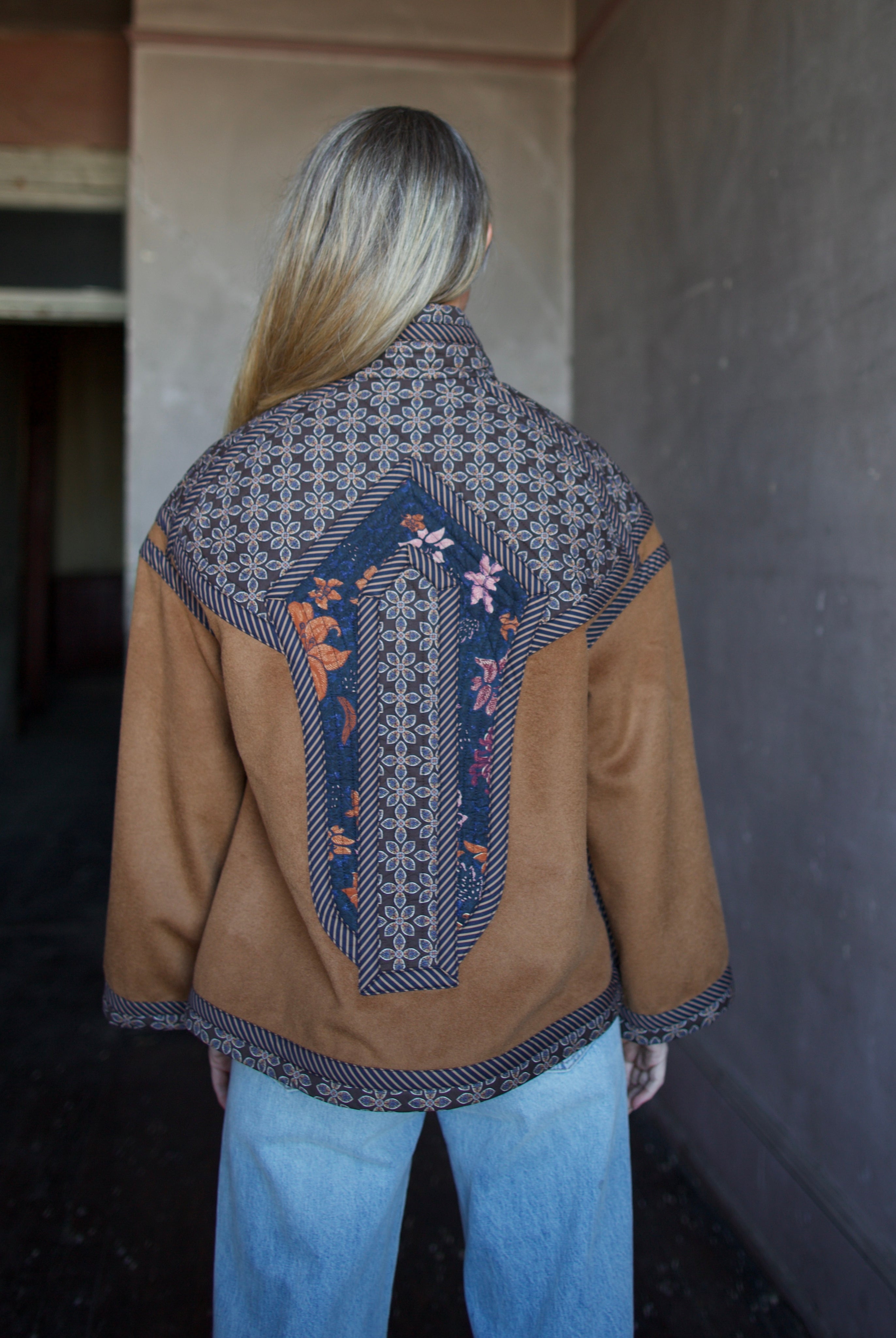 Image of the back of a woman wearing the Cara Cara Ford Jacket and the slvrlake grace jeans