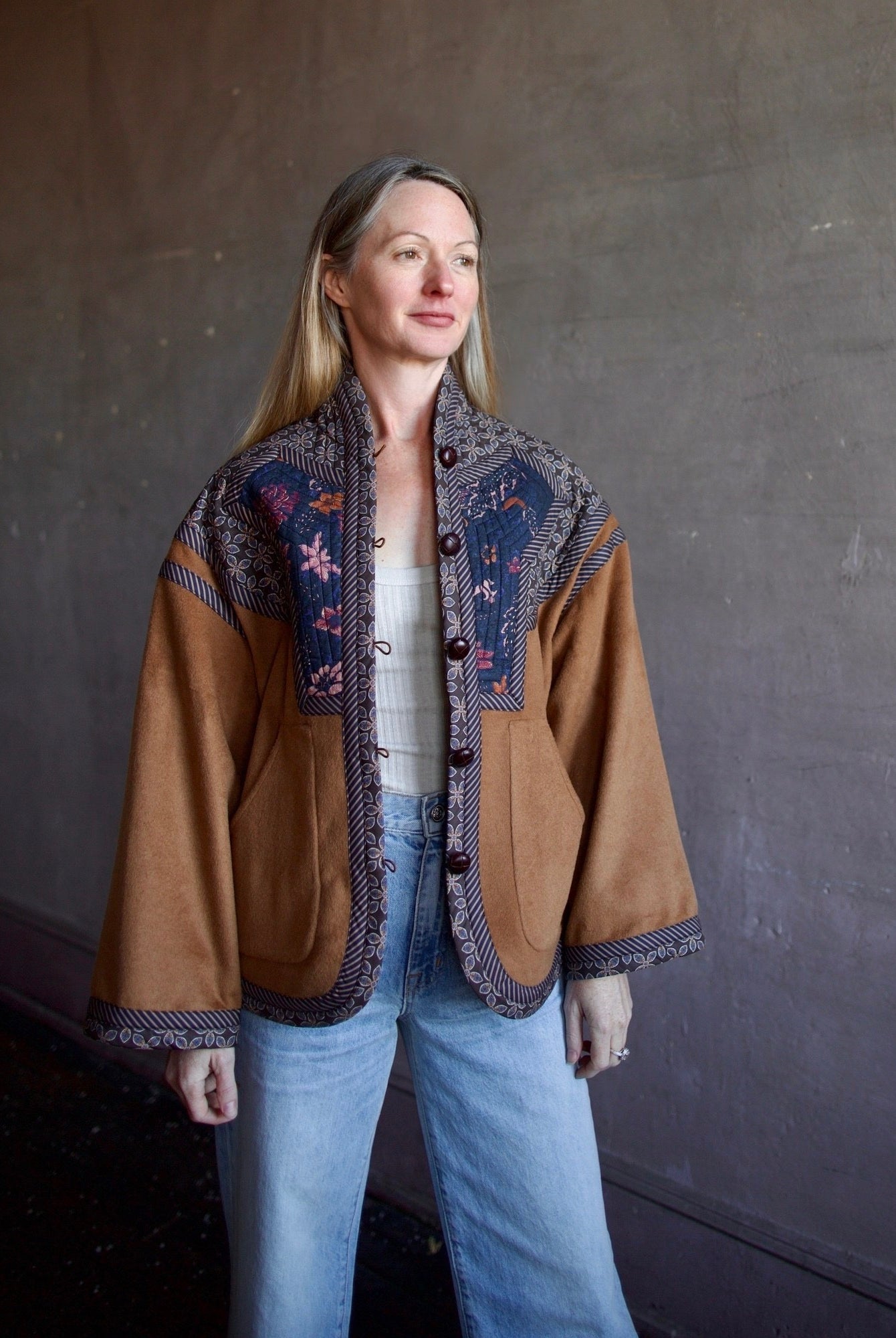 Image of a woman wearing the Cara Cara Ford Jacket, Enza Costa Ribbed Tank and the slvrlake grace jeans