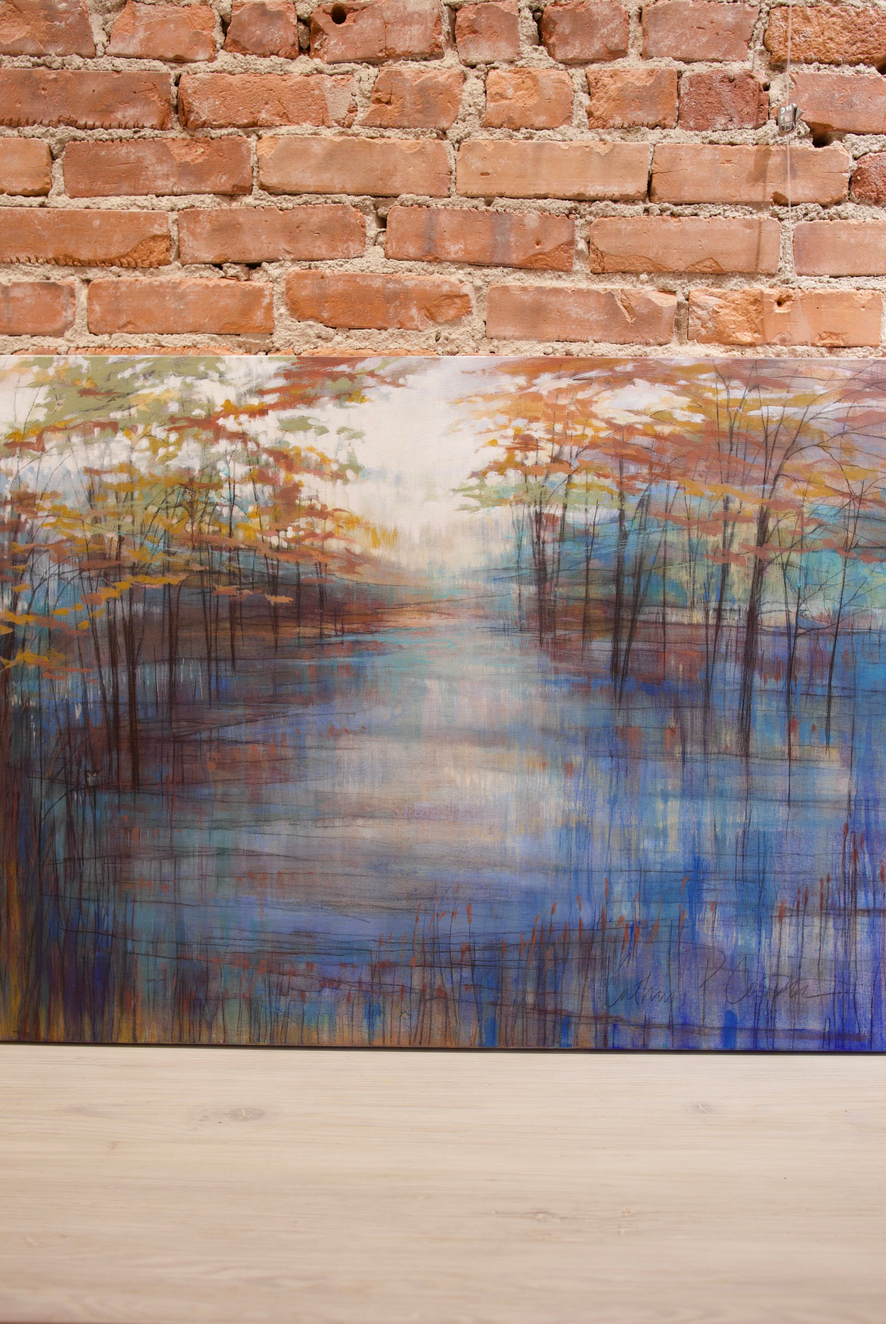 Original Acrylic and graphite painting by North Carolina Artist Cathryn Cooper depicting fall foliage on the water’s edge with a clear white sky.