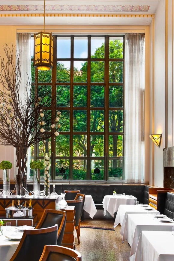 Image showing the interior of Eleven Madison Park restaurant on the left and the front cover of 'The Cookbook