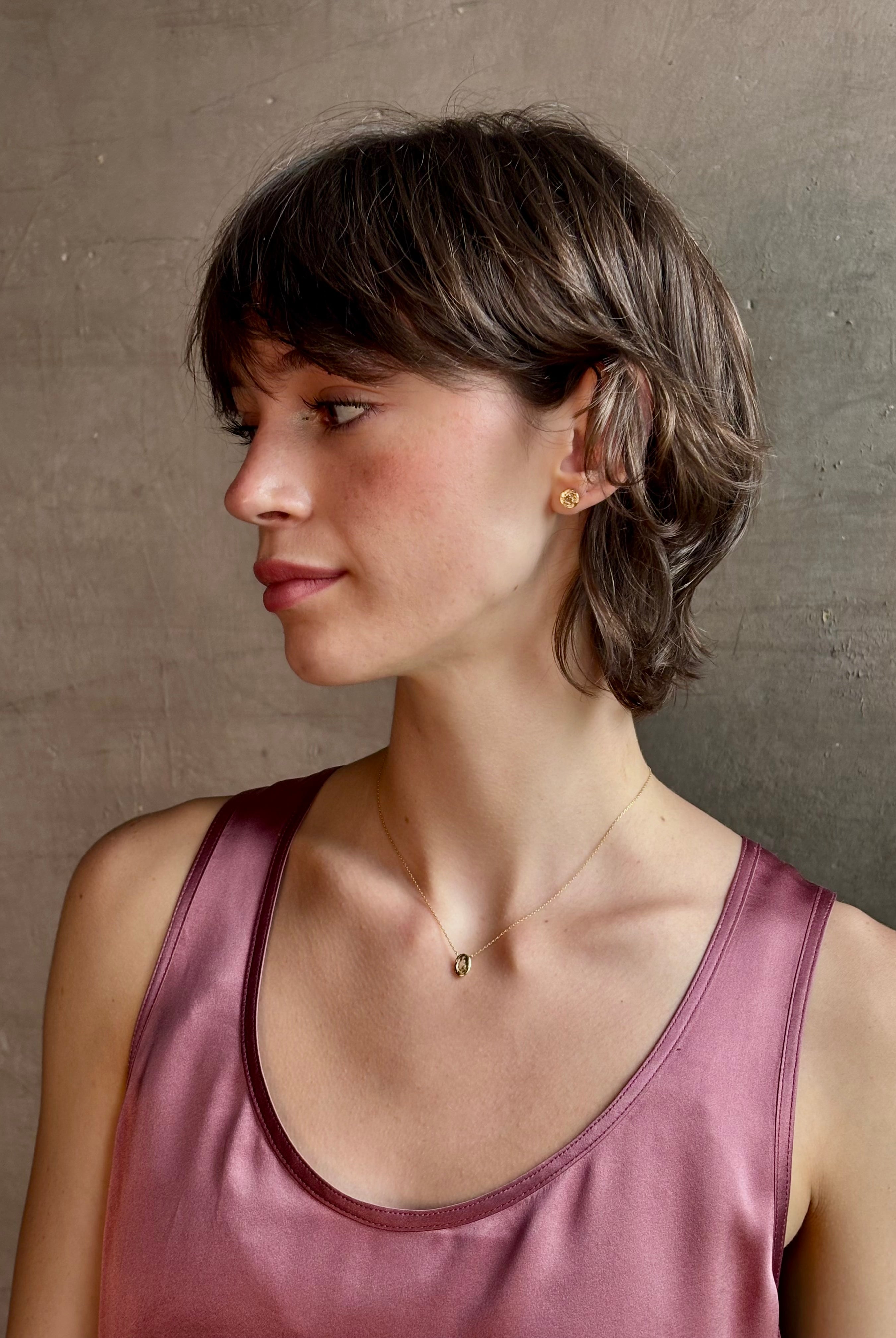 Woman wearing White Sapphire Pendant Necklace from fine jewelry designer Emilie Shapiro exquisitely handcrafted in USA and sustainably considered 14K yellow gold