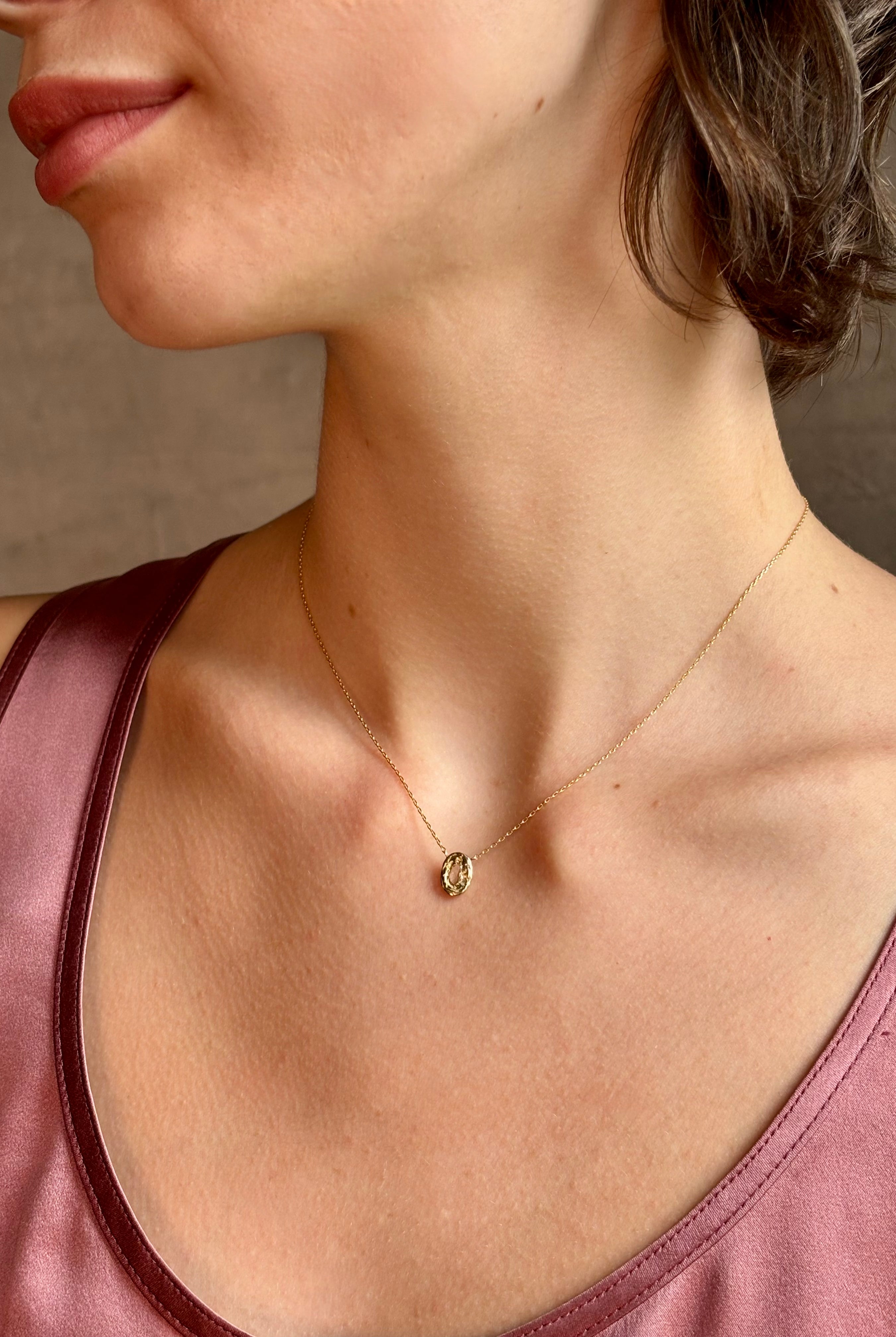 Woman wearing White Sapphire Pendant Necklace from fine jewelry designer Emilie Shapiro exquisitely handcrafted in USA and sustainably considered 14K yellow gold