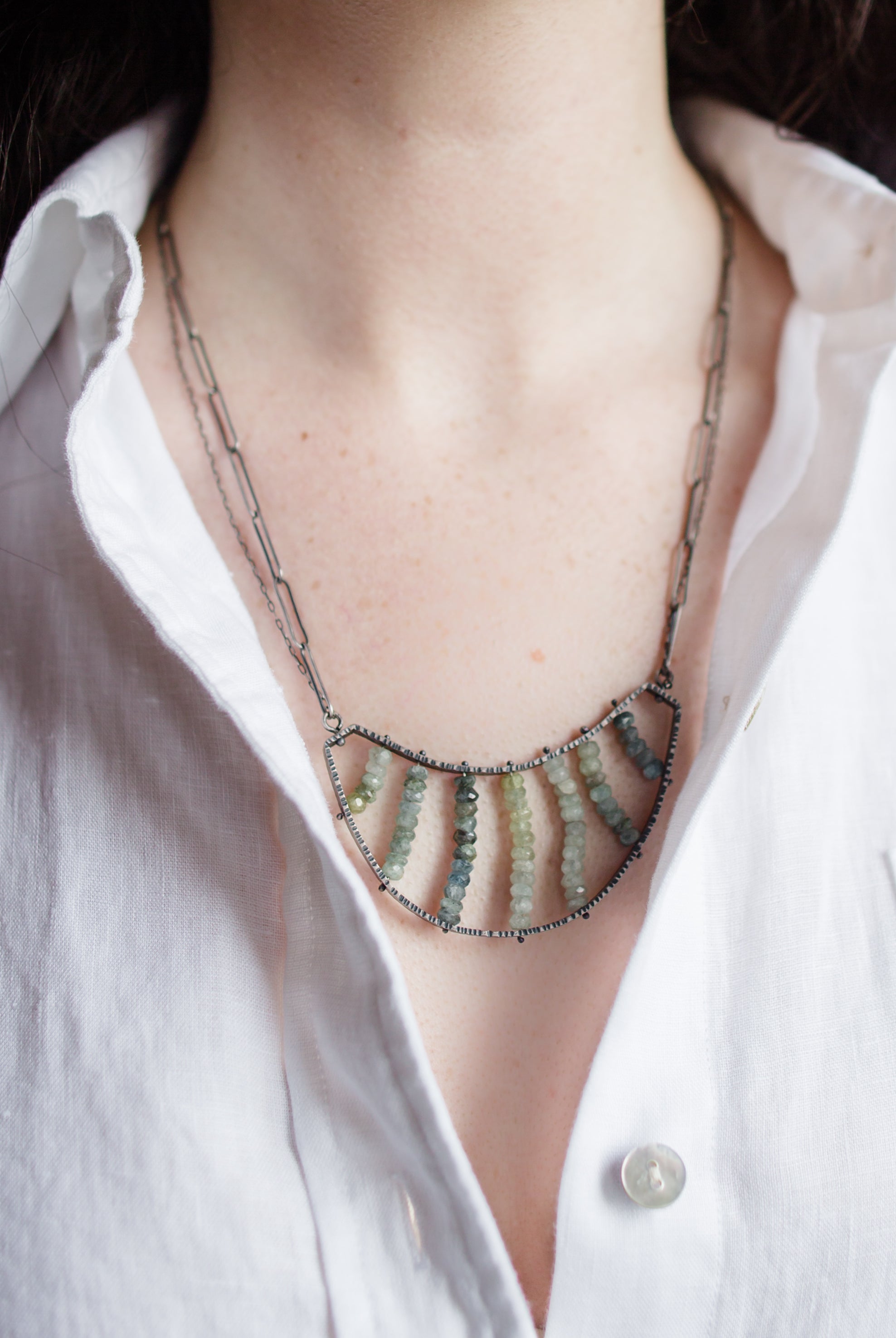 Woman wearing a sterling silver double necklace with Apatite stones handmade in USA by North Carolina jewelry artist Erica Bailey