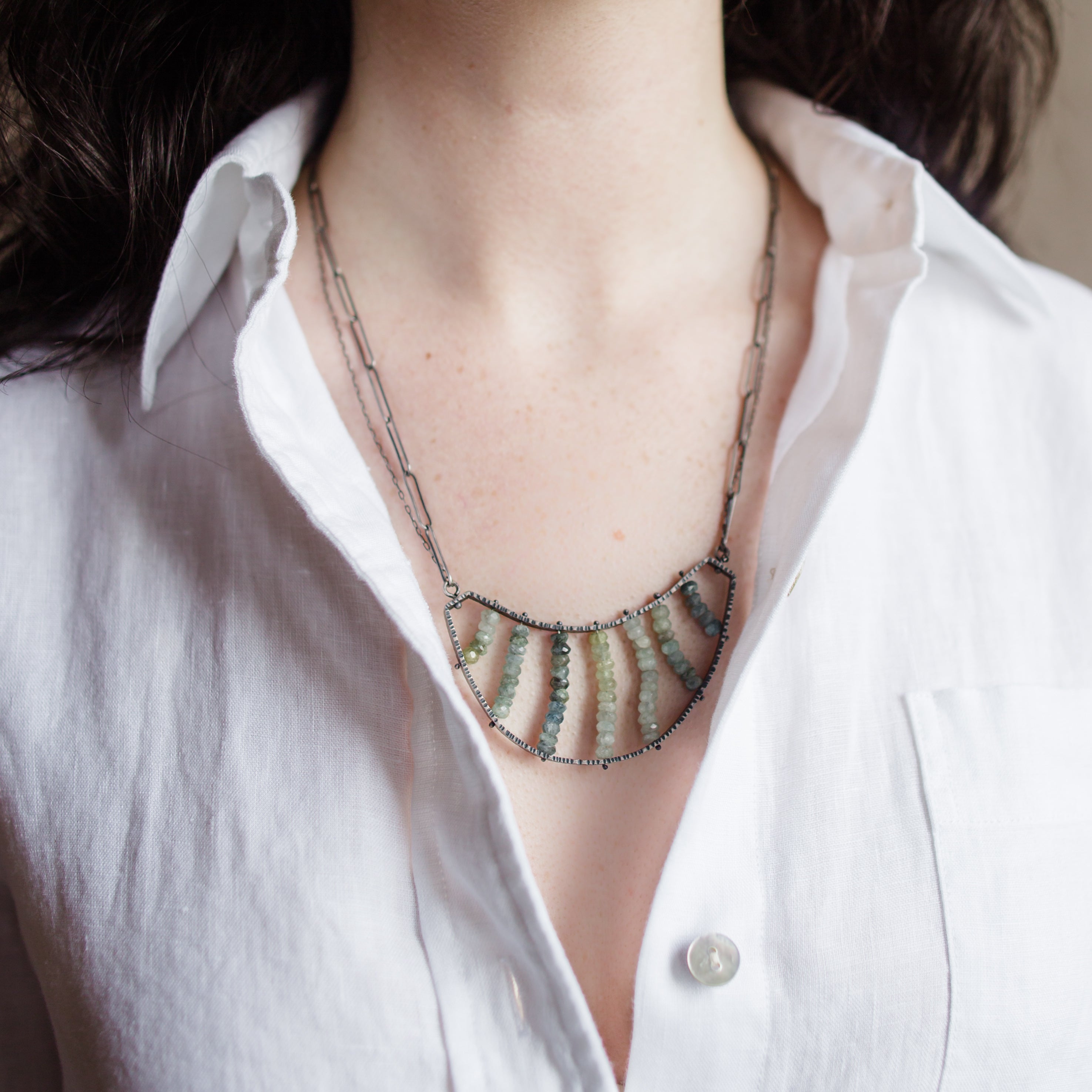 Woman wearing a sterling silver double necklace with Apatite stones handmade in USA by North Carolina jewelry artist Erica Bailey