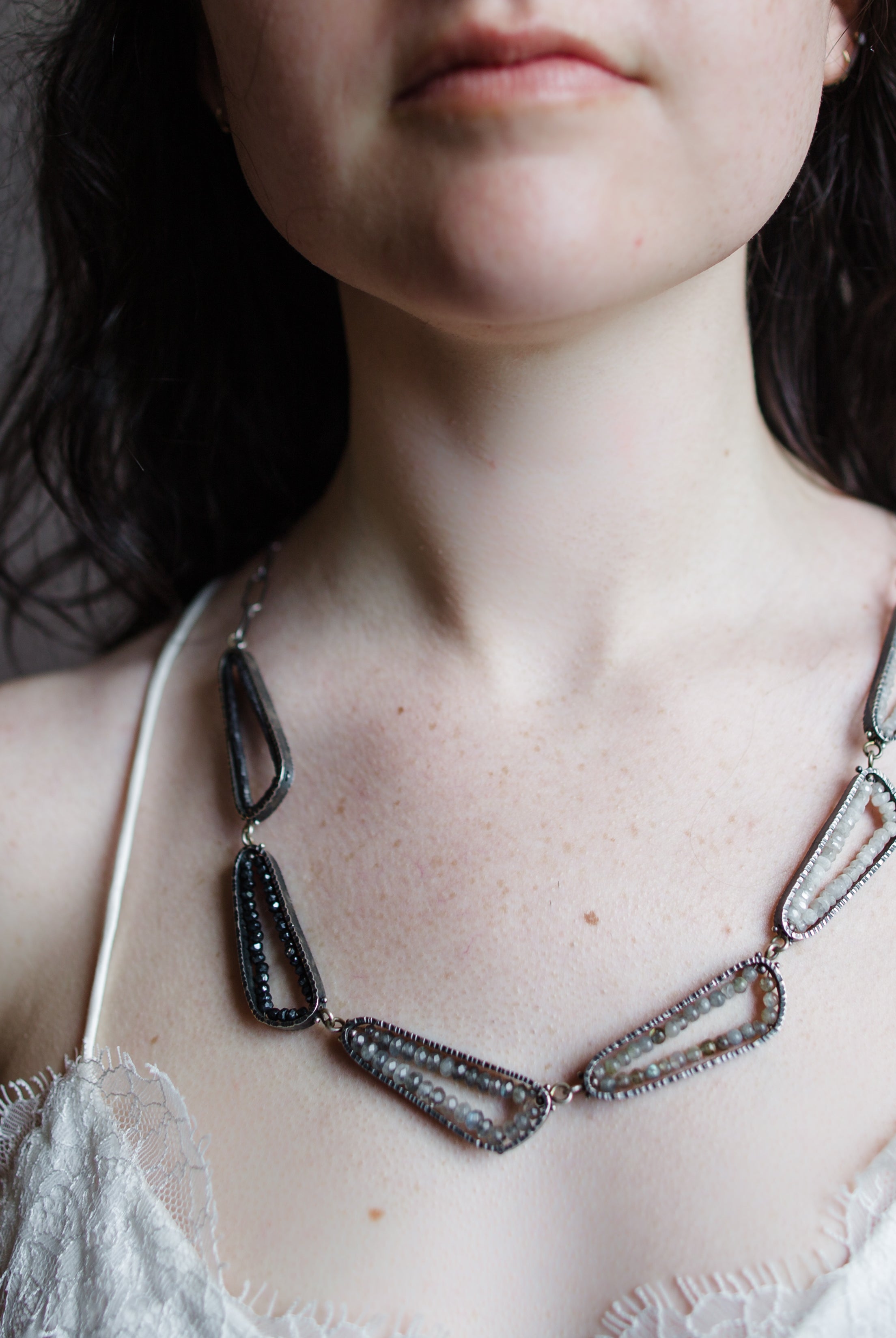 Woman wearing Neutral Ombre statement Necklace from fine jewelry designer Erica Bailey handcrafted in USA