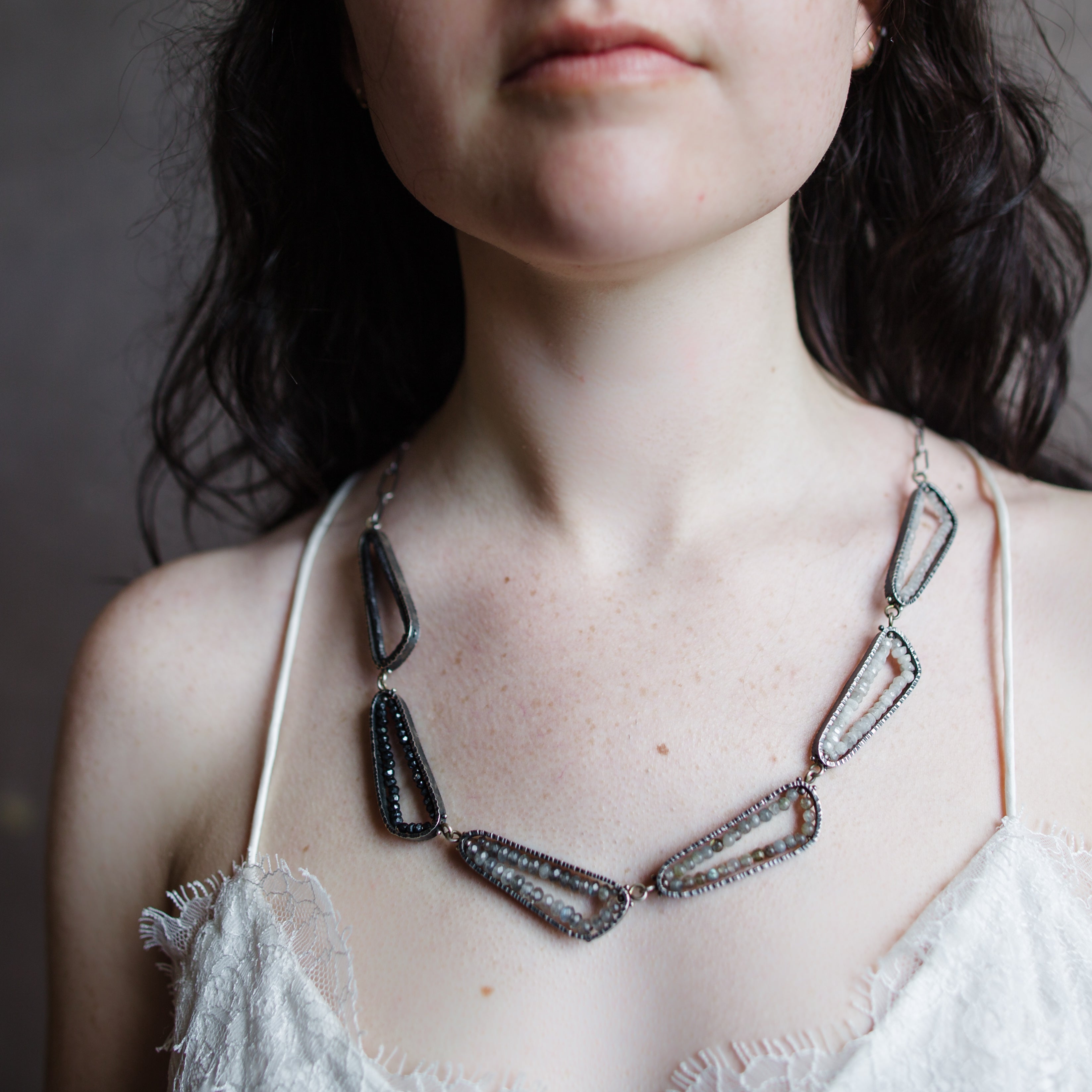 Woman wearing Neutral Ombre statement Necklace from fine jewelry designer Erica Bailey handcrafted in USA