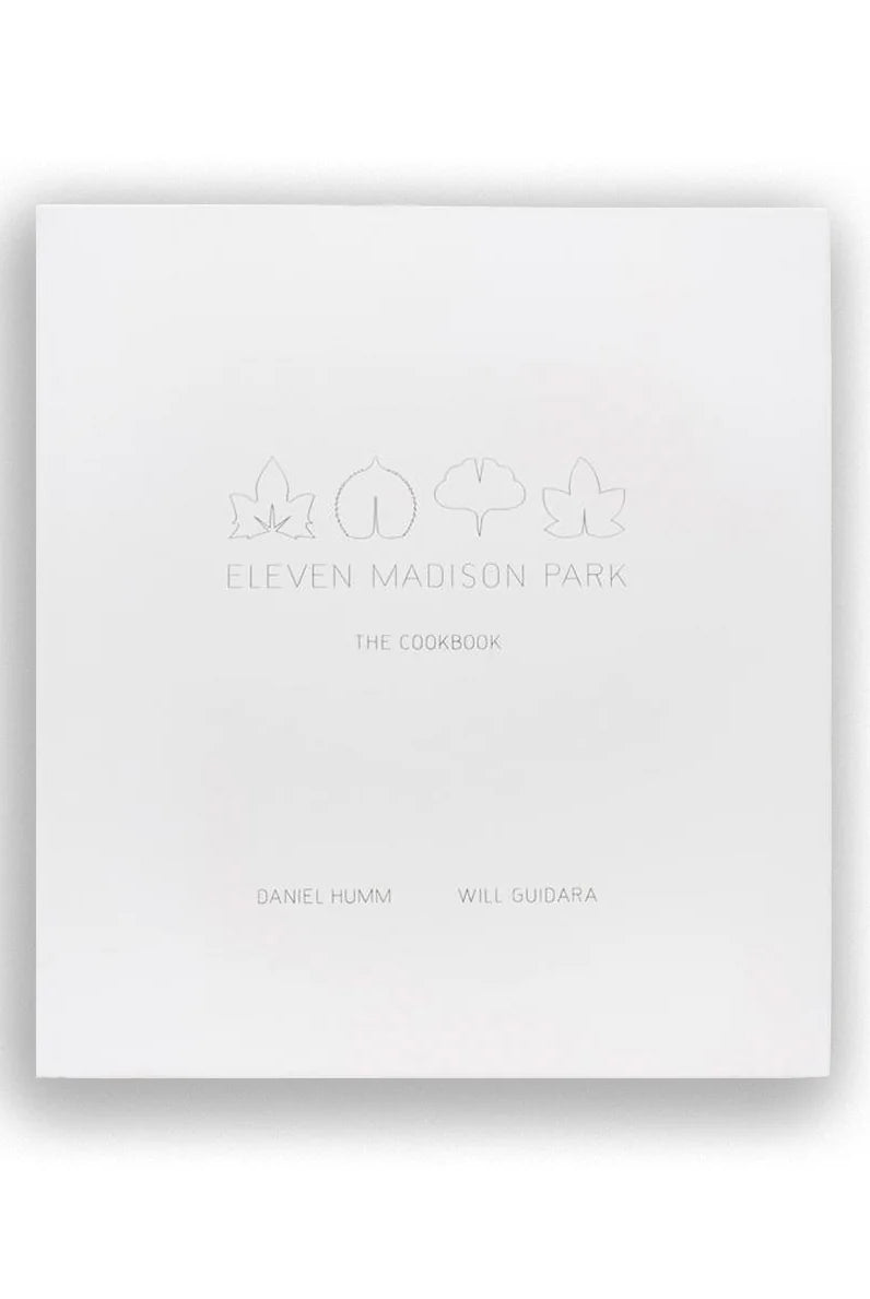 The front cover of the cookbook 'Eleven Madison Park: The Cookbook' by Daniel Humm and Will Gudala