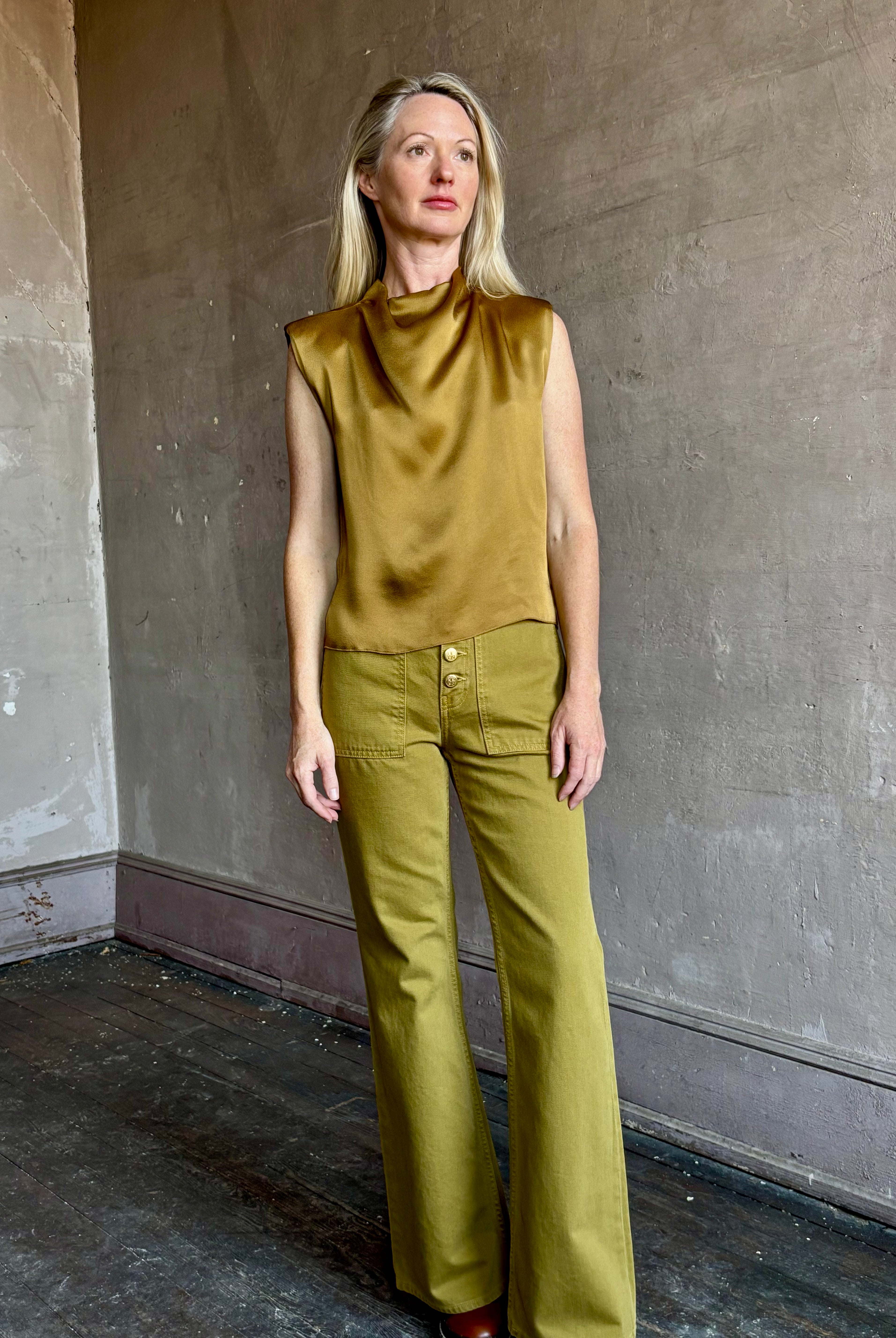 Image of mature woman wearing luxury Italian designer FORTE FORTE Envers Satin Crater-Neck sleeveless Shirt in matte Antique Gold