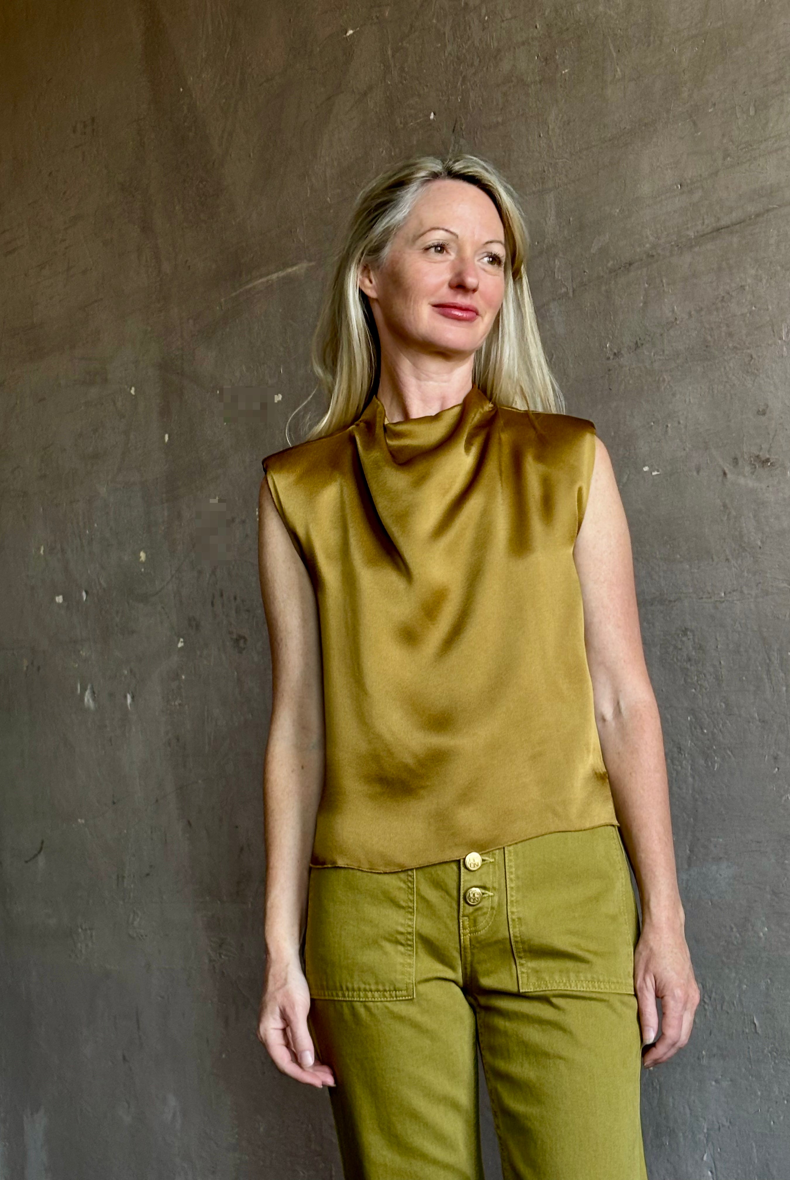Image of mature woman wearing luxury Italian designer FORTE FORTE Envers Satin Crater-Neck sleeveless Shirt in matte Antique Gold