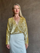 Image of mature woman wearing luxury Italian designer FORTE FORTE En Rêve Fil-Coup metallic velvet honey Shirt with V-neck and long sleeves
