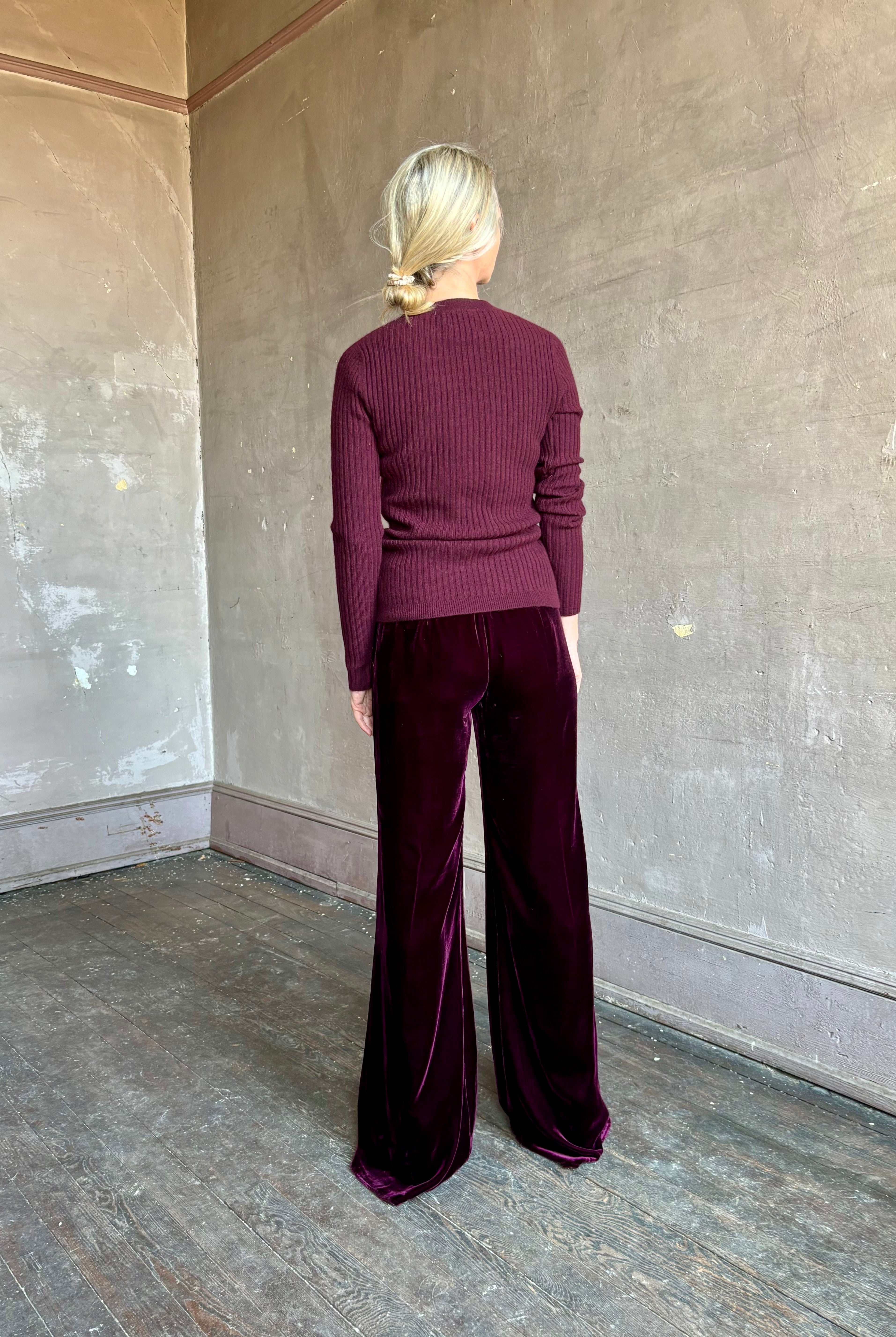 Image of mature woman wearing luxury Italian designer FORTE FORTE Plain Velvet Flare Pants in Bordeaux with flat front and flare leg