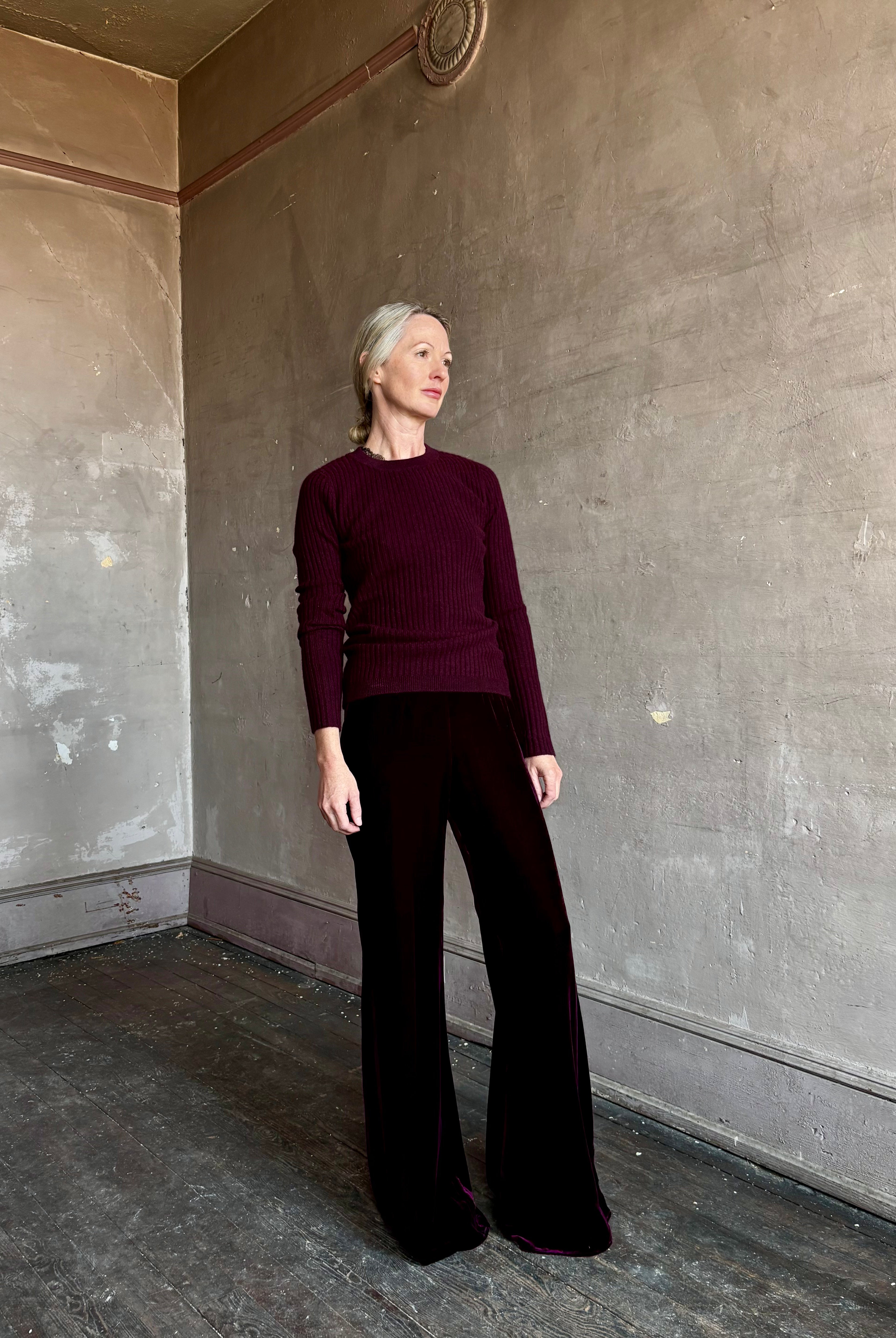 Image of mature woman wearing luxury Italian designer FORTE FORTE Plain Velvet Flare Pants in Bordeaux with flat front and flare leg