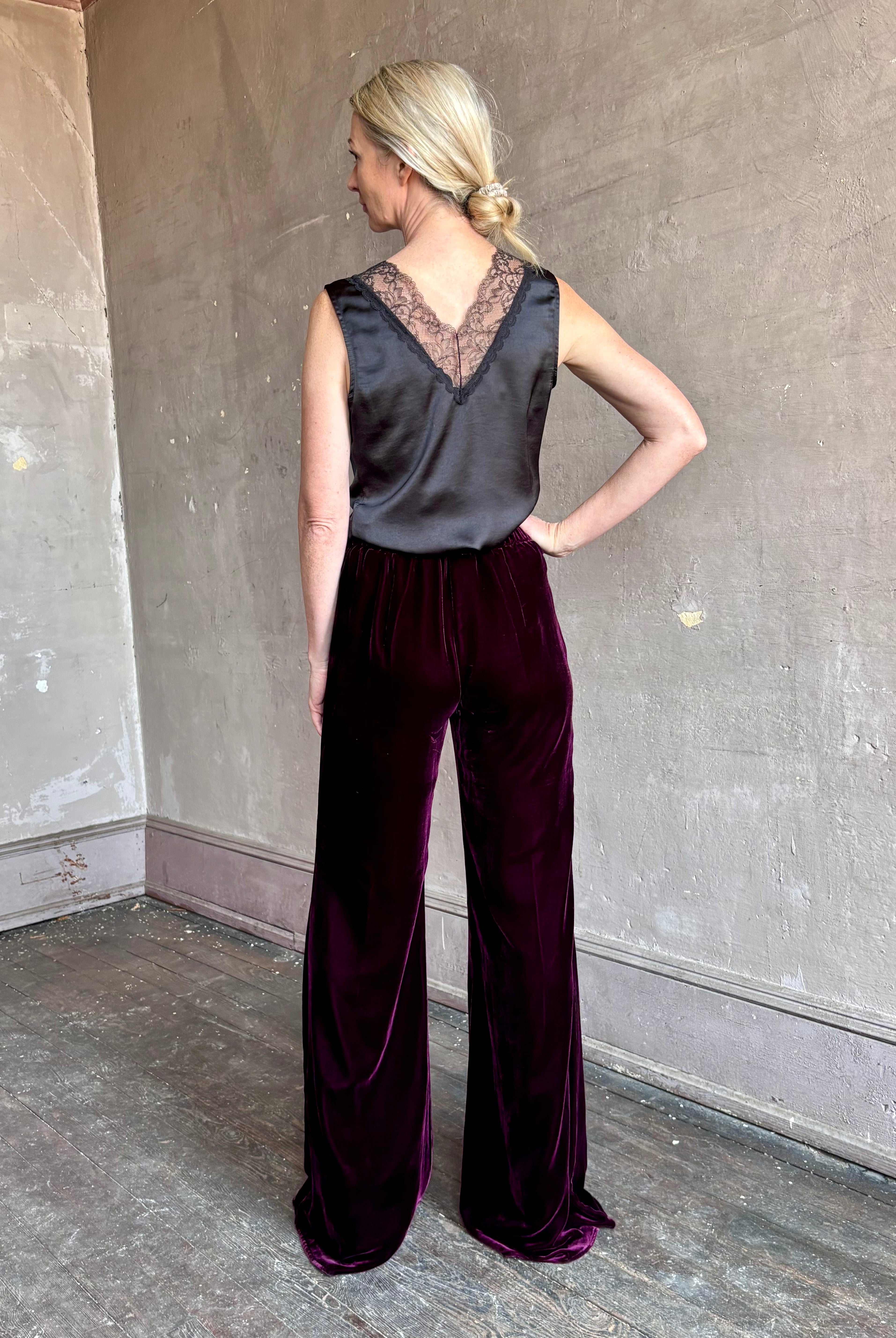 Image of mature woman wearing luxury Italian designer FORTE FORTE Plain Velvet Flare Pants in Bordeaux with flat front and flare leg