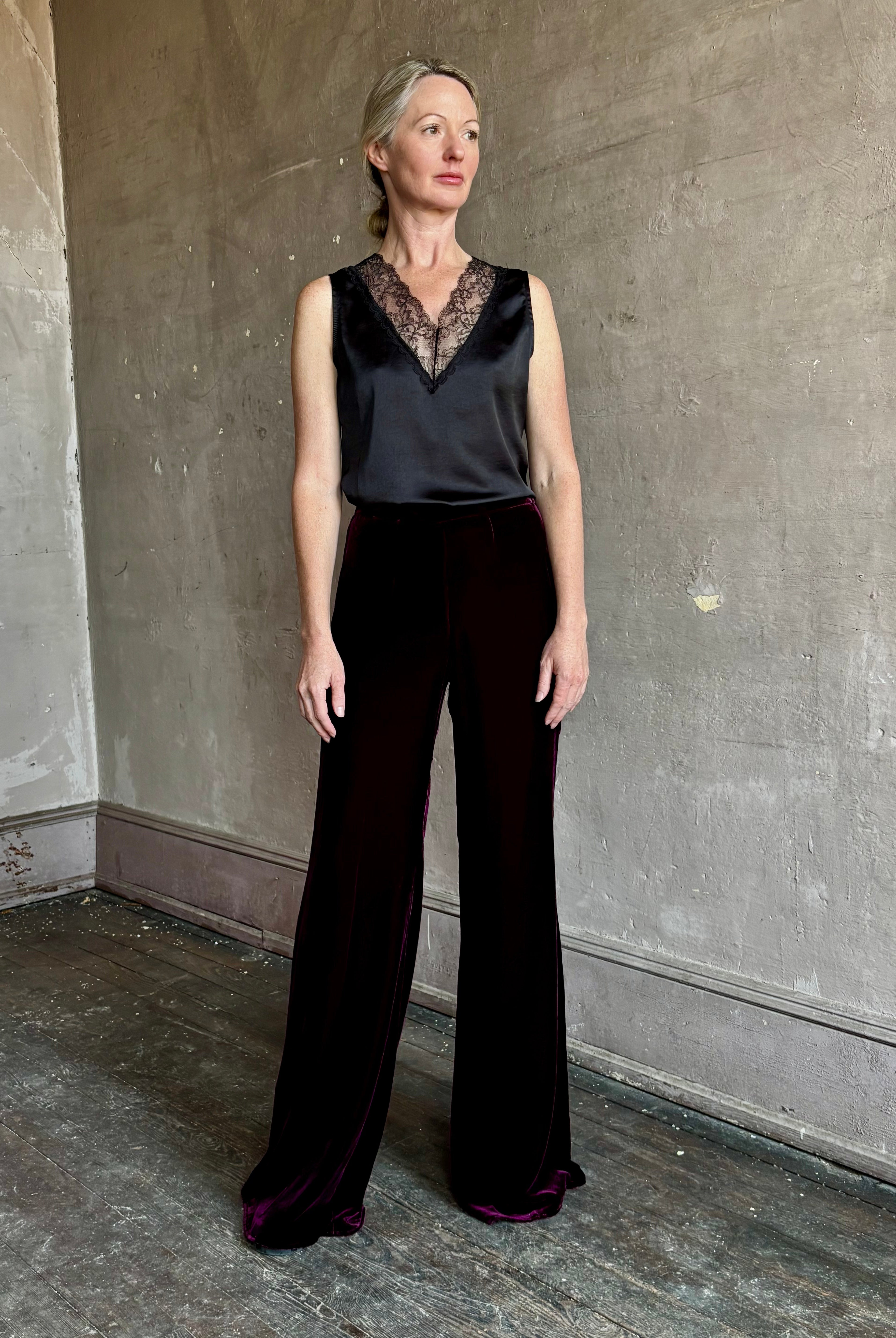 Image of mature woman wearing luxury Italian designer FORTE FORTE Plain Velvet Flare Pants in Bordeaux with flat front and flare leg