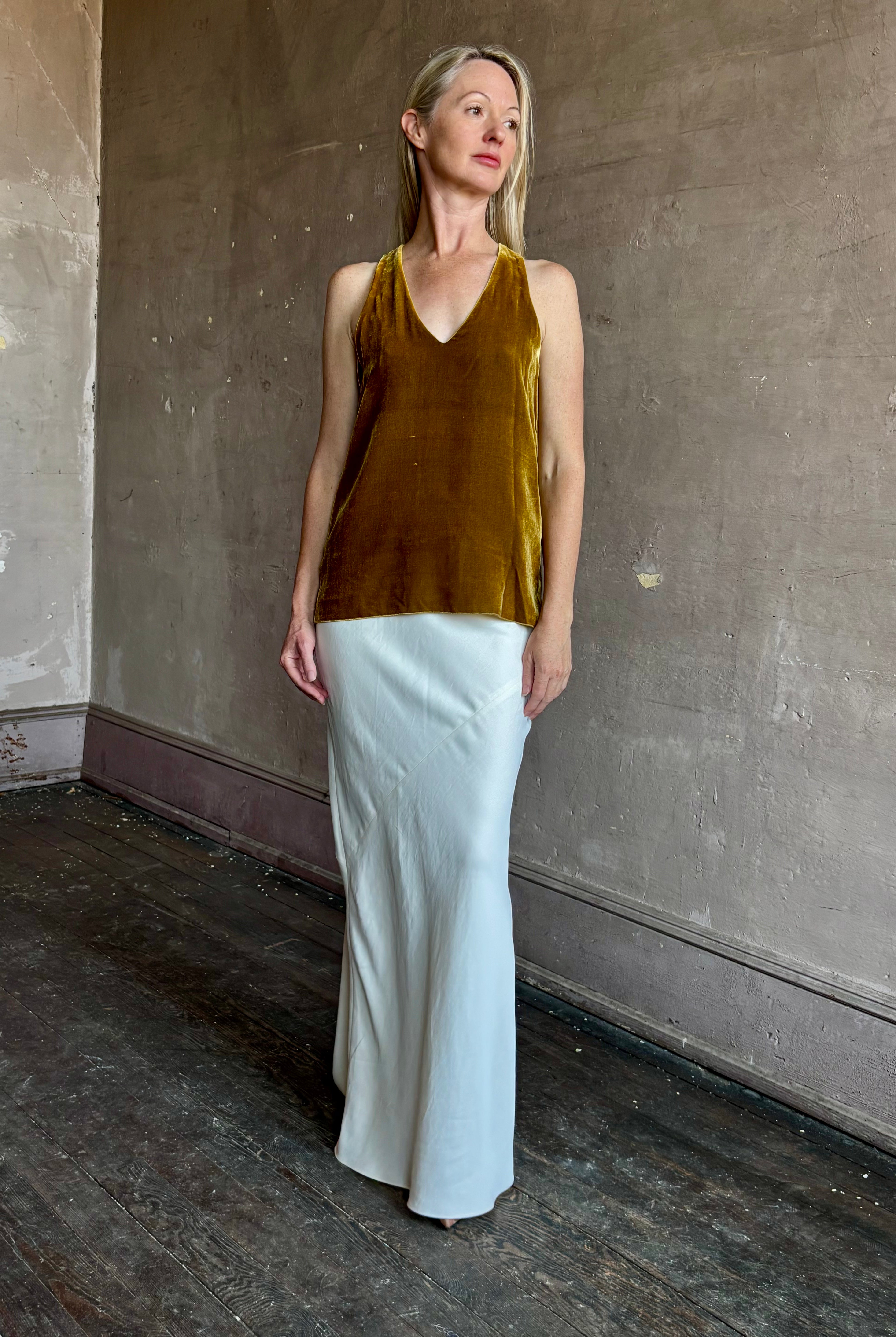 Image of mature woman wearing luxury Italian designer FORTE FORTE Plain sleeveless Velvet V Neck Top in Antique Gold with exquisite draping