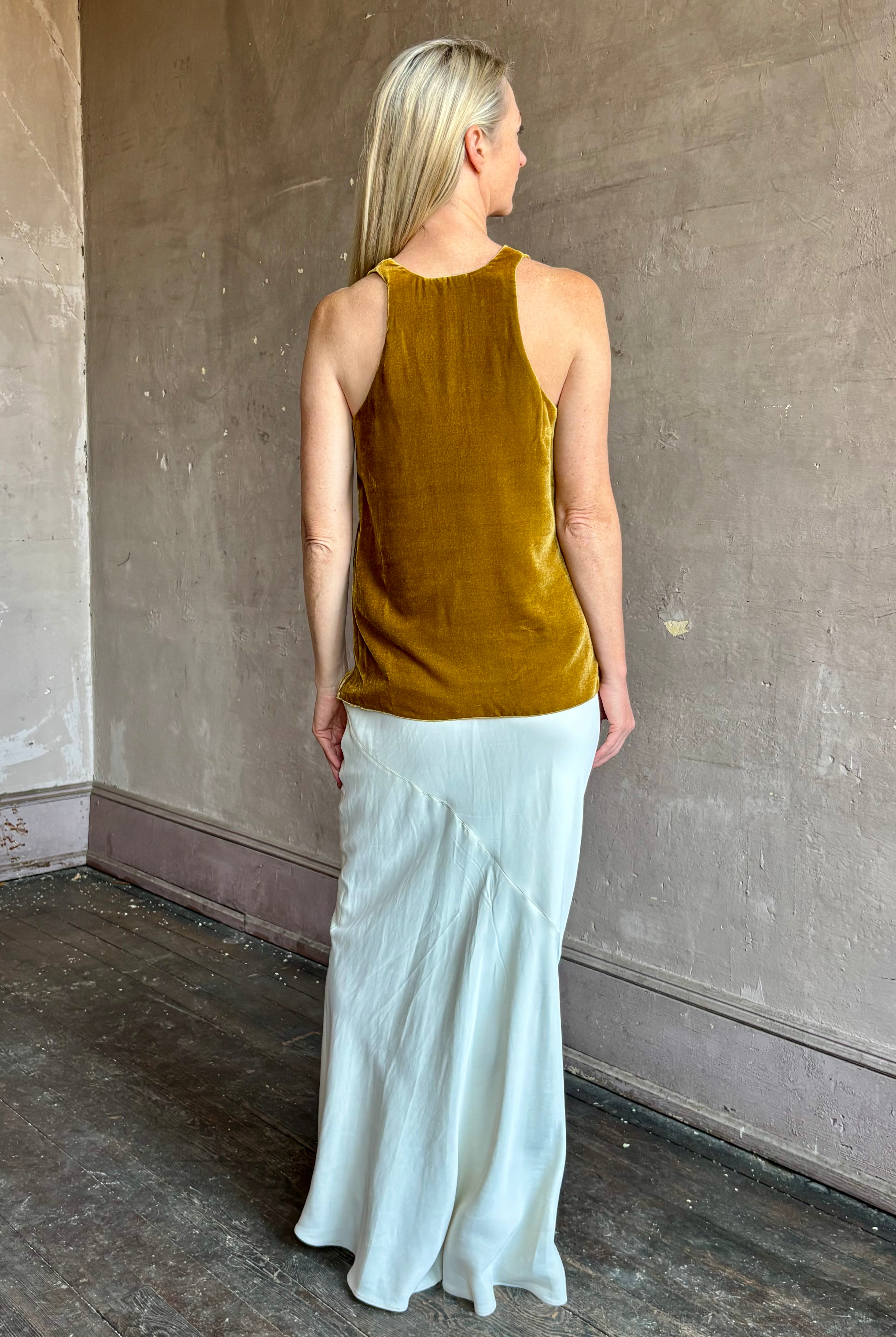 Image of mature woman wearing luxury Italian designer FORTE FORTE Plain Velvet V Neck Top in Antique Gold with exquisite draping