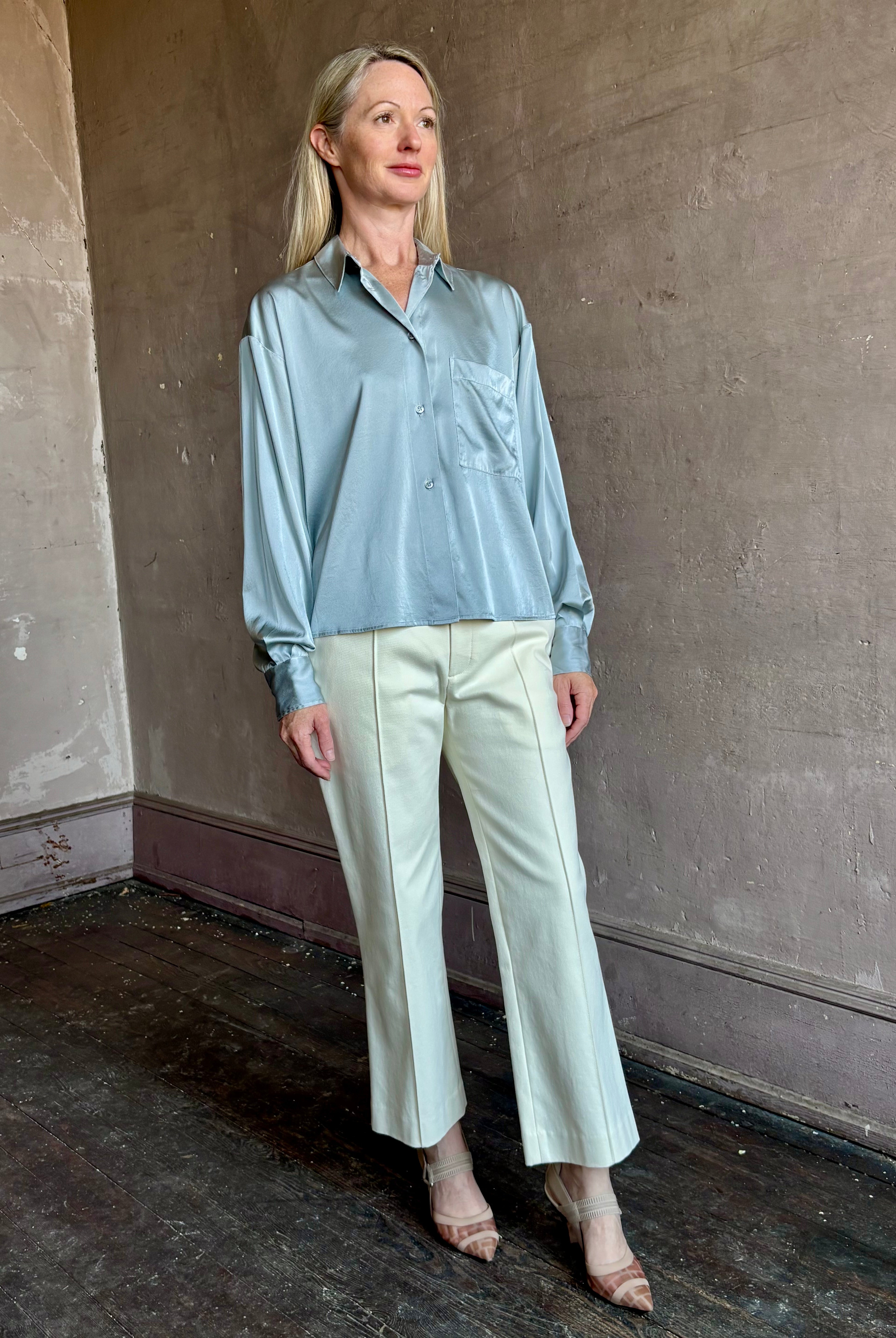 Image of mature woman wearing luxury Italian designer FORTE FORTE Stretch Silk Satin Cropped button down long sleeve Shirt in steel blue