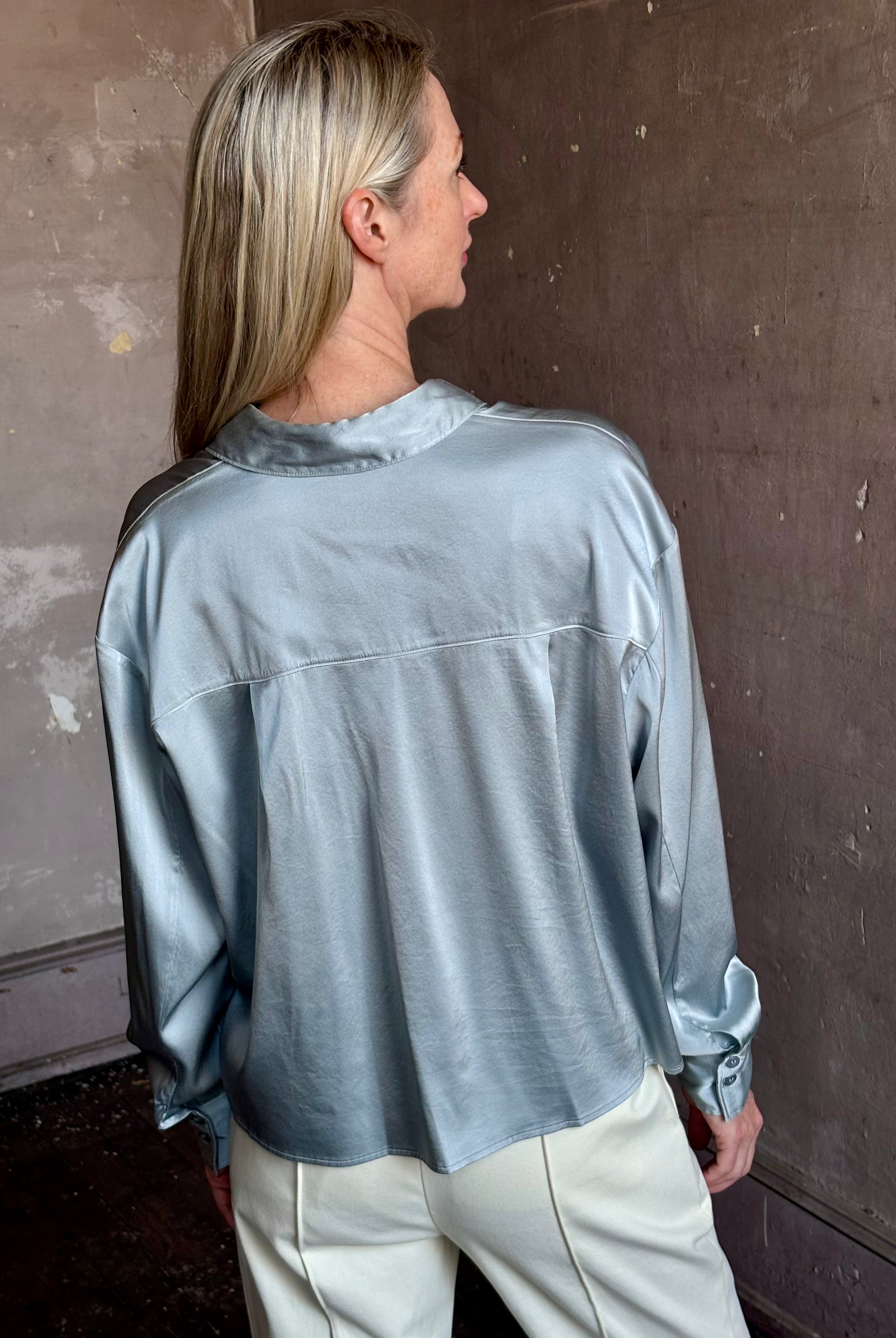 Image of mature woman wearing luxury Italian designer FORTE FORTE Stretch Silk Satin Cropped button down long sleeve Shirt in steel blue