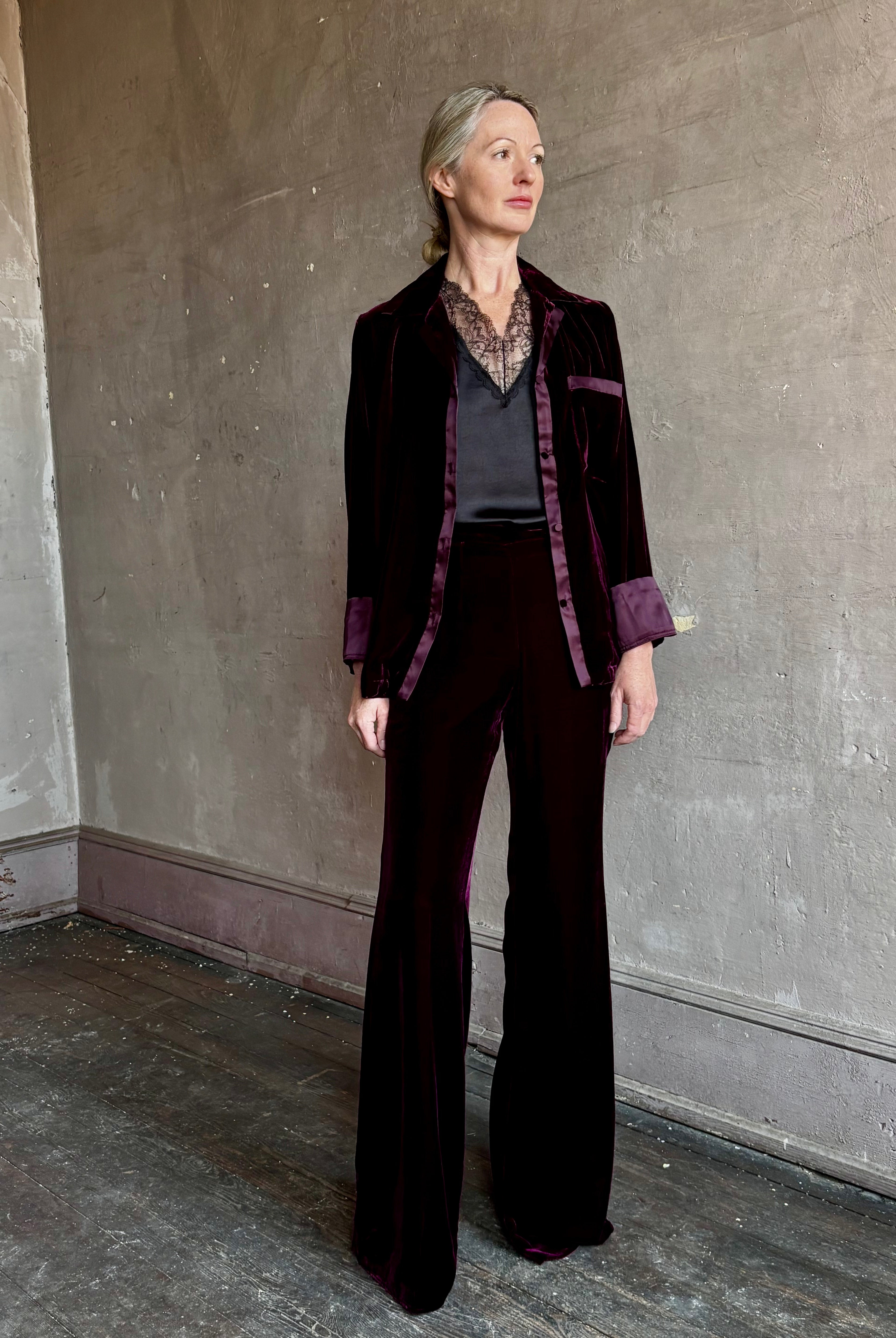 Image of mature woman wearing luxury Italian designer FORTE FORTE Plain Velvet Flare Pants in Bordeaux with flat front and flare leg