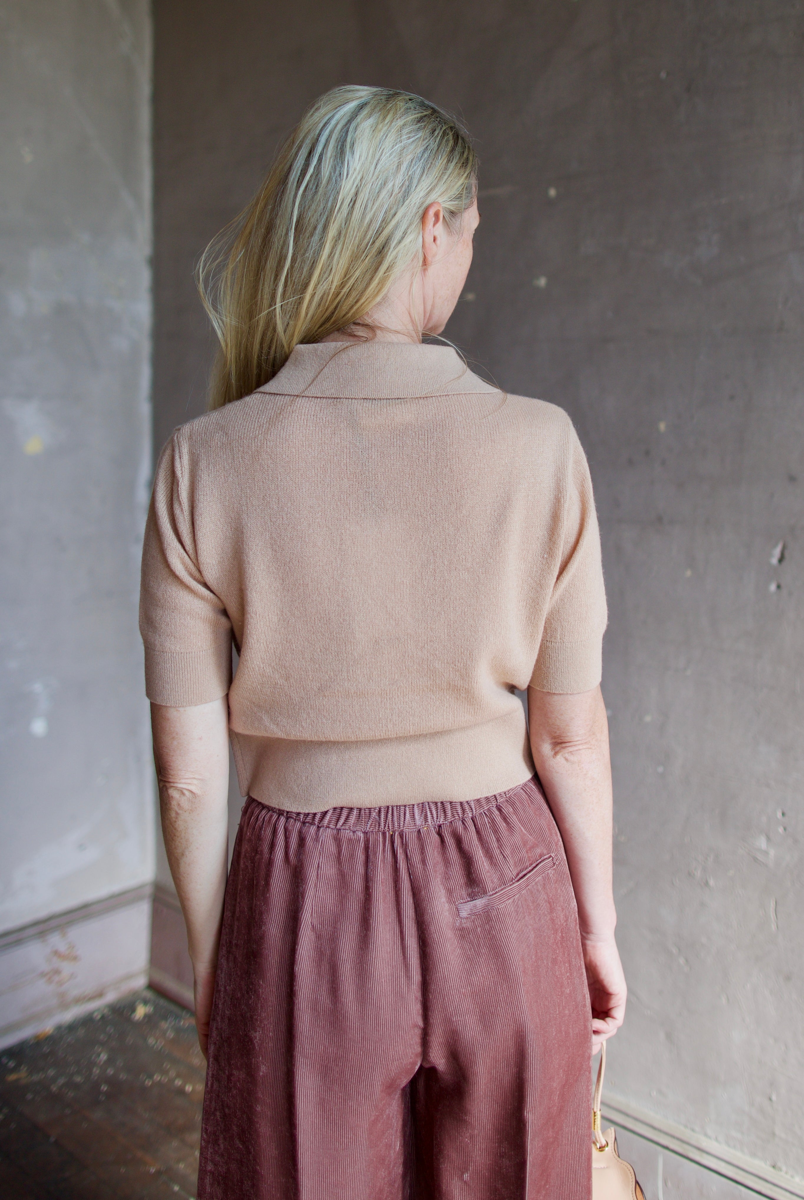 Model wearing luxury Italian designer Forte Forte wool and cashmere short sleeve polo sweater with short sleeves