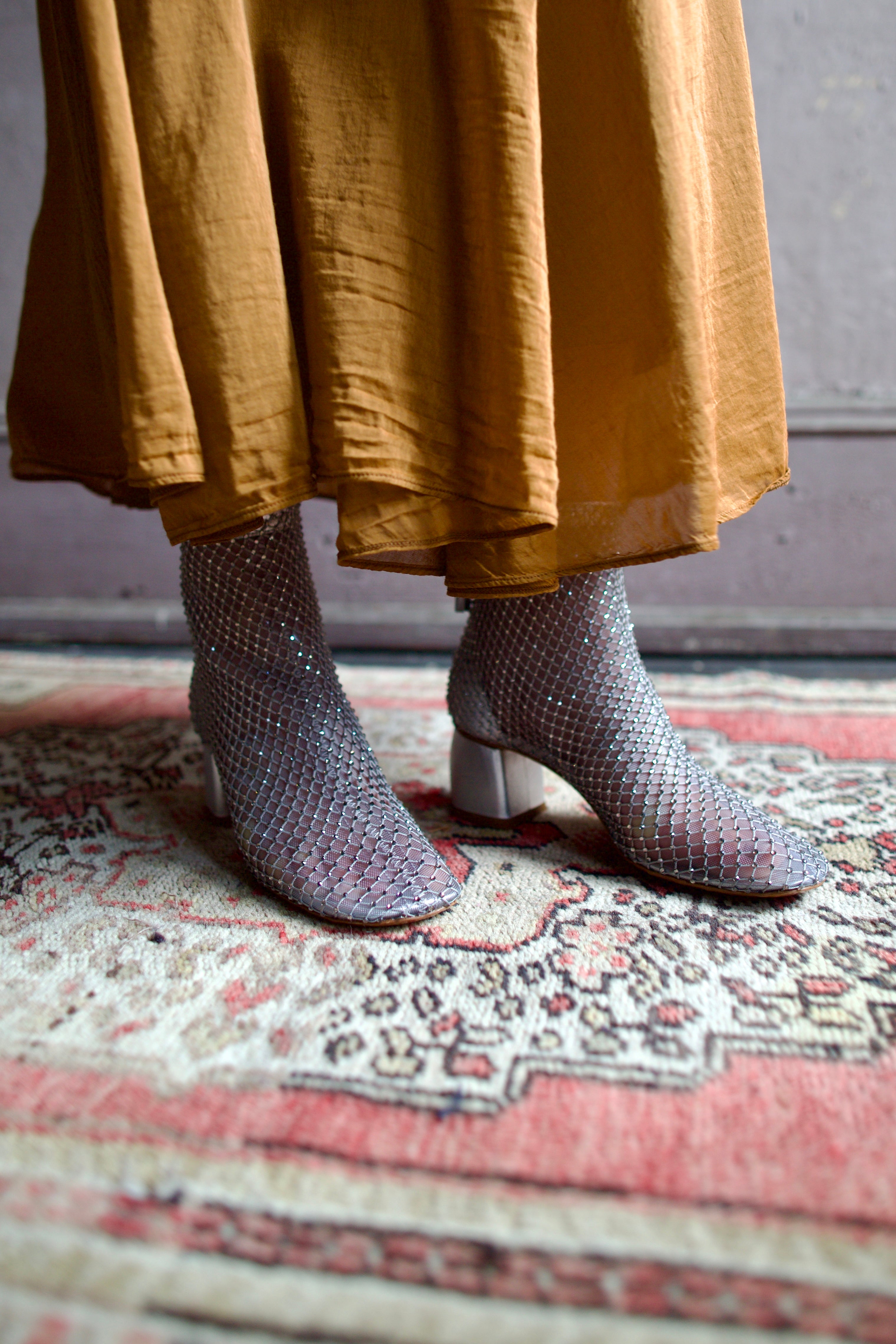 Model wearing luxury Italian designer Forte Forte mesh sheer silver ankle boot with elusive gleaming crystals.