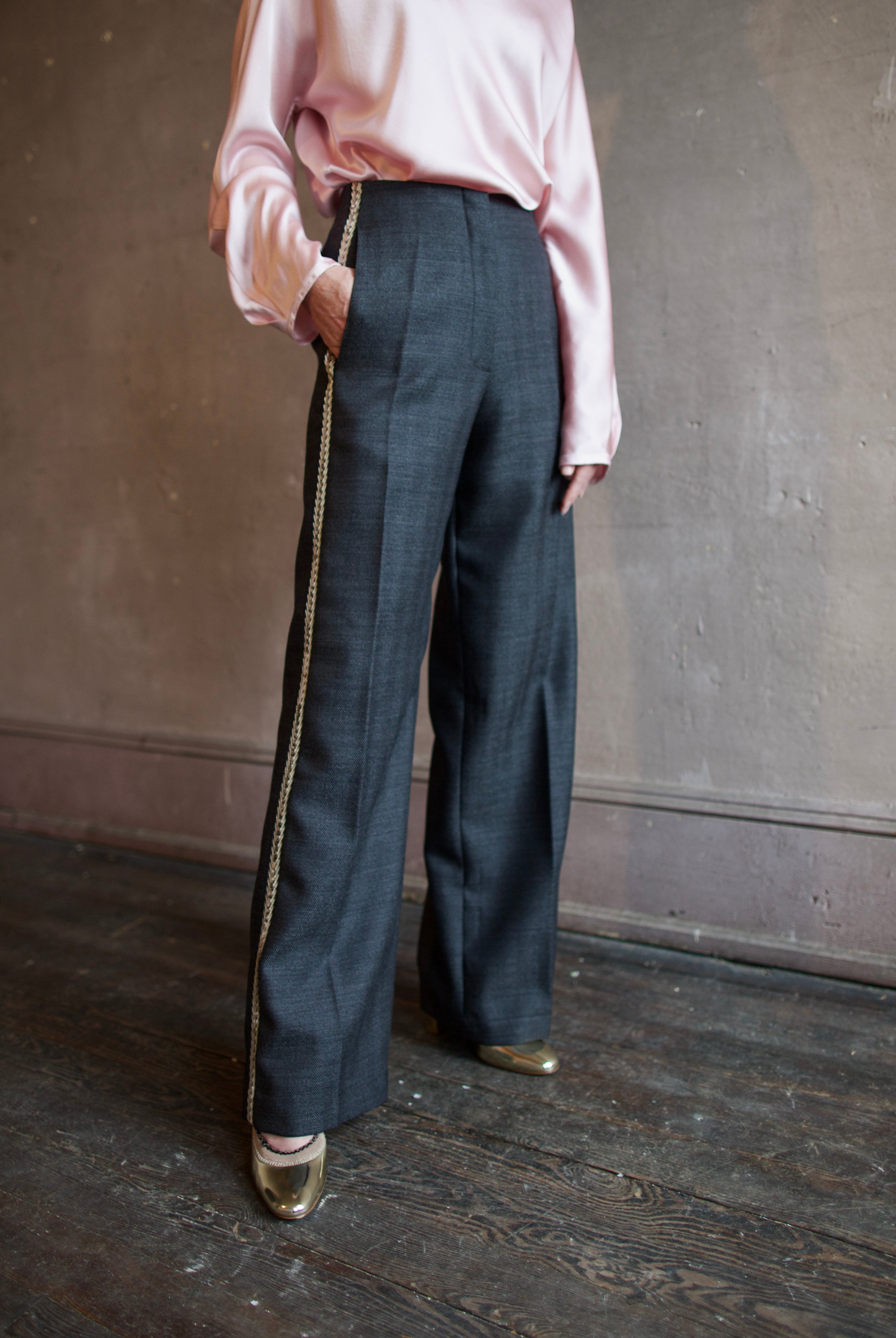 Image featuring a woman wearing herringbone pants by Forte Forte with a mid rise, straight leg and beaded embellishment along one side.